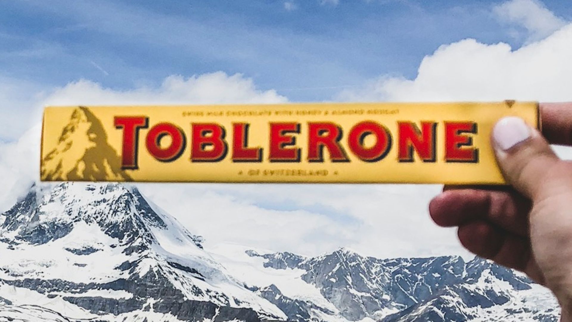 person holding Toblerone chocolate box