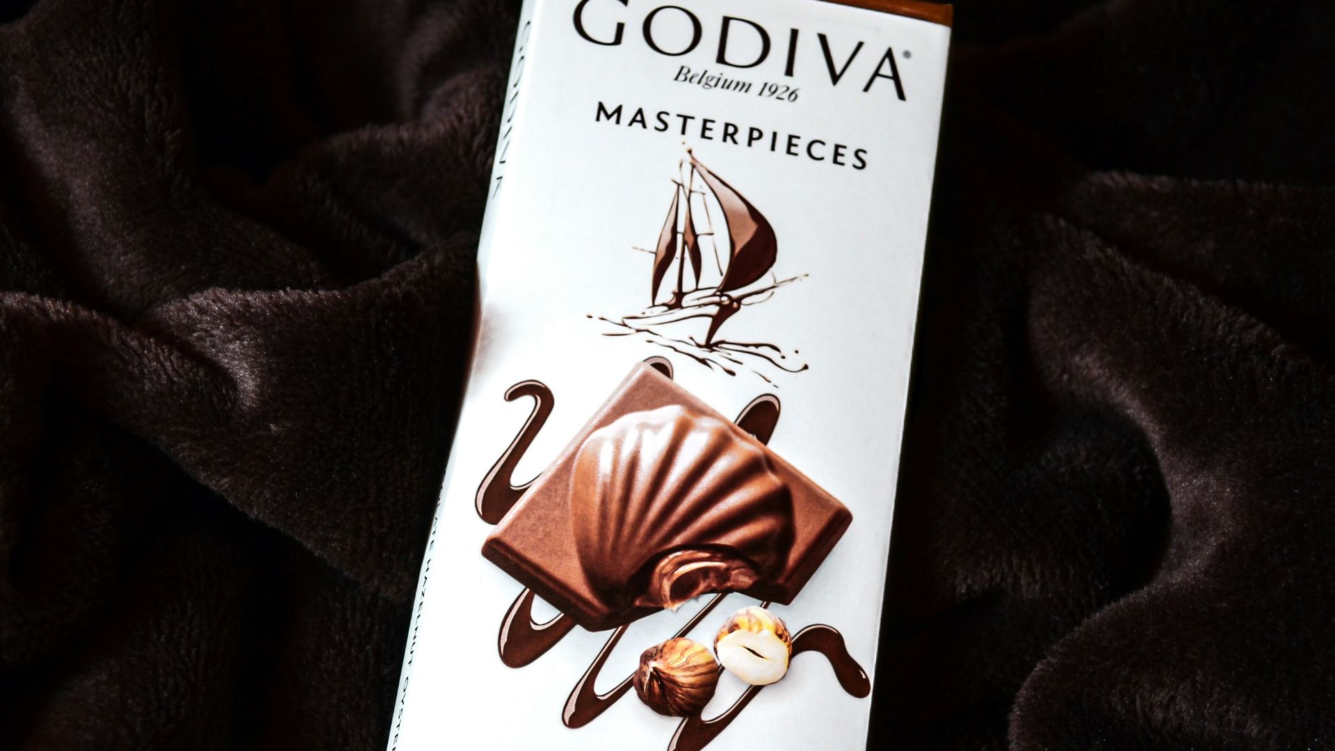 a bar of milk chocolate on a black blanket