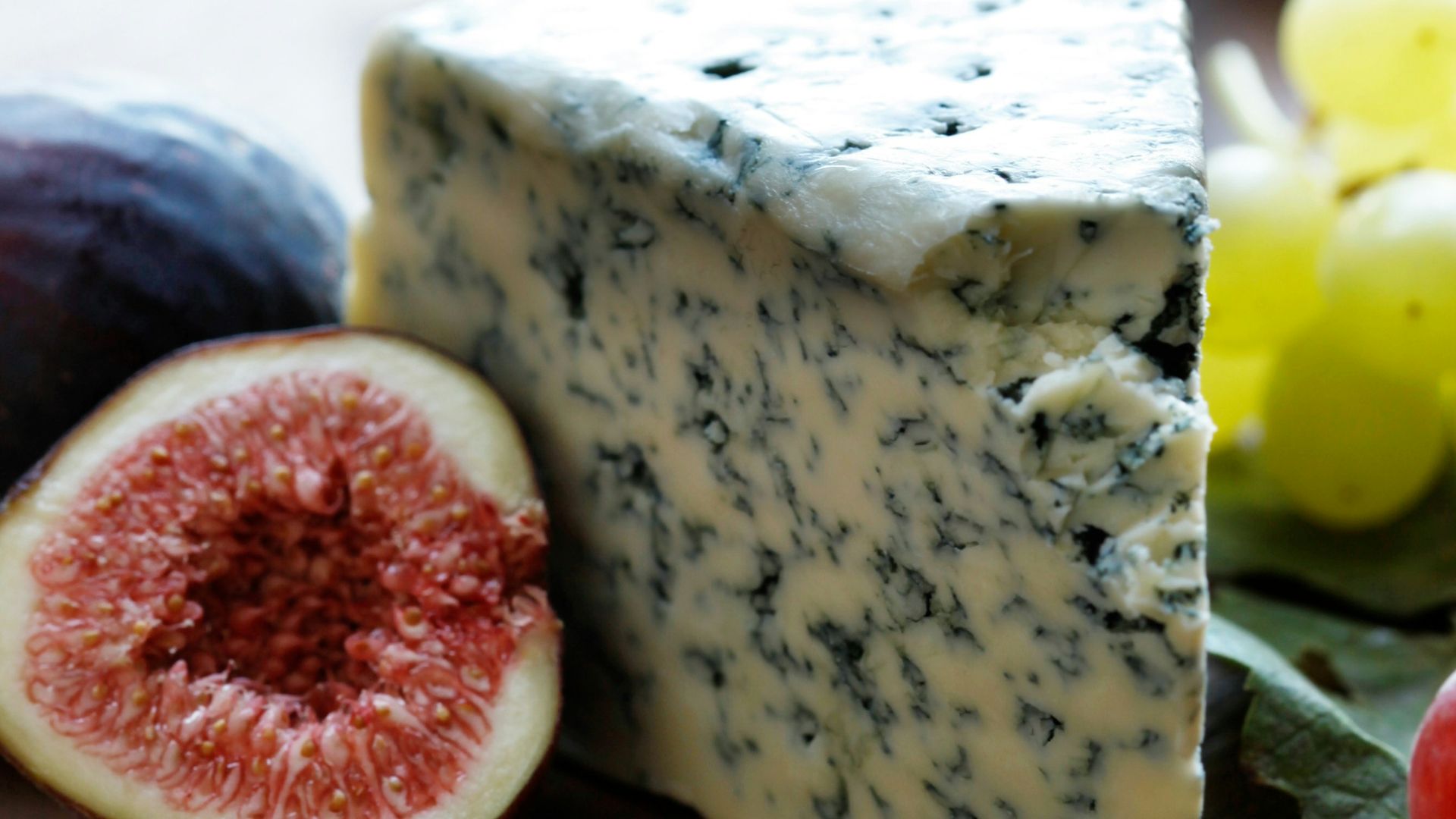 fruits and cheese on wooden surface