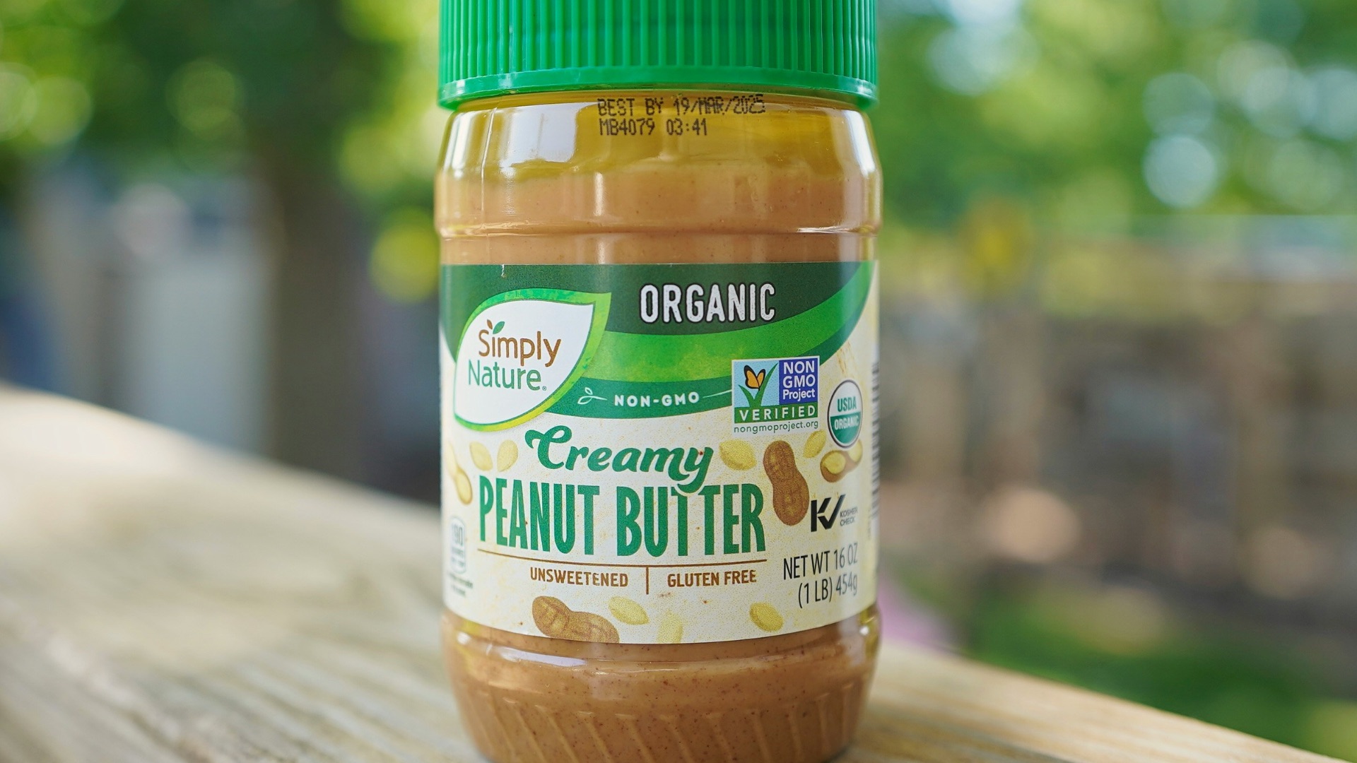 A jar of peanut butter sitting on top of a wooden table