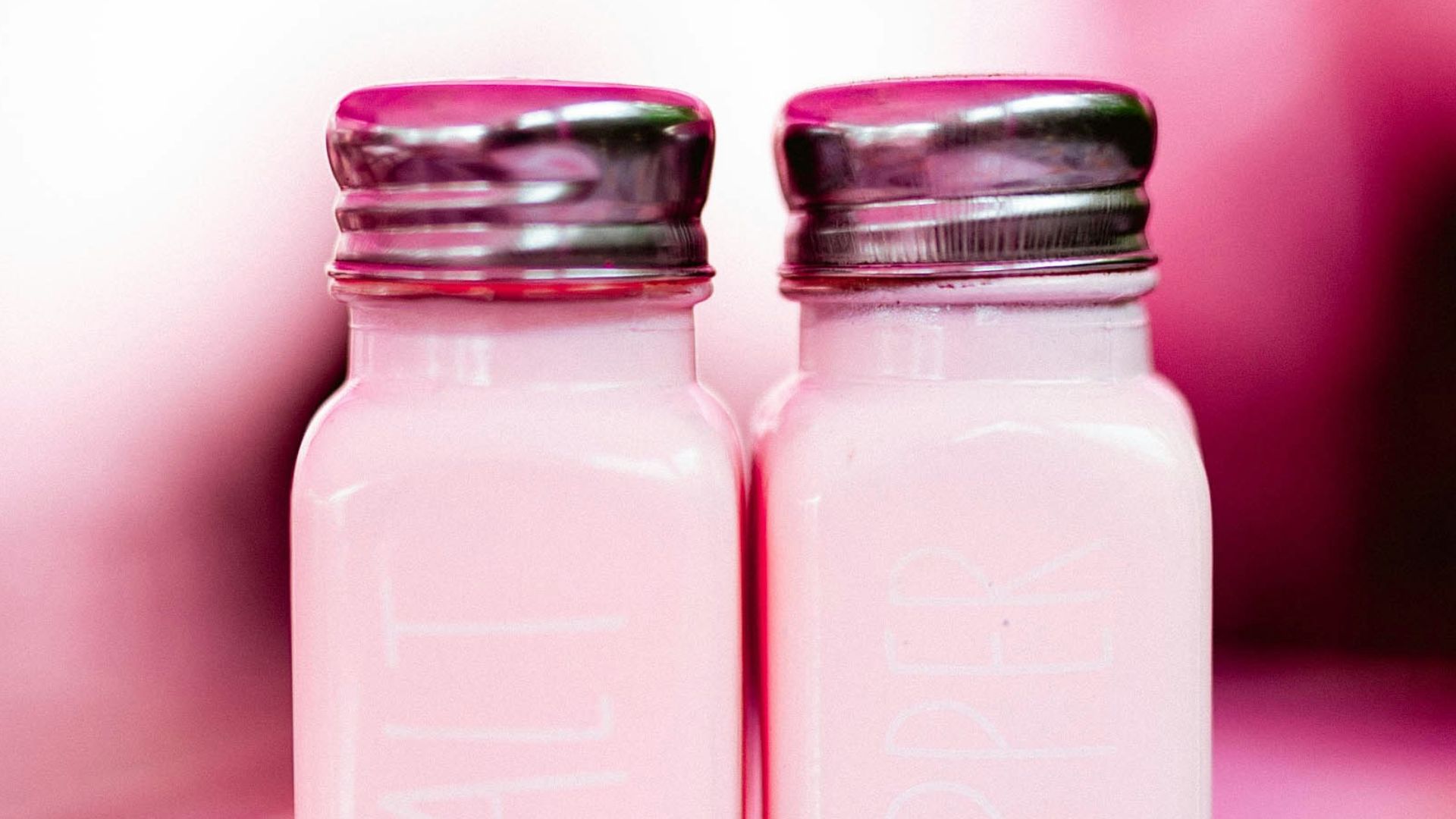 Two glass jars sitting on top of a table