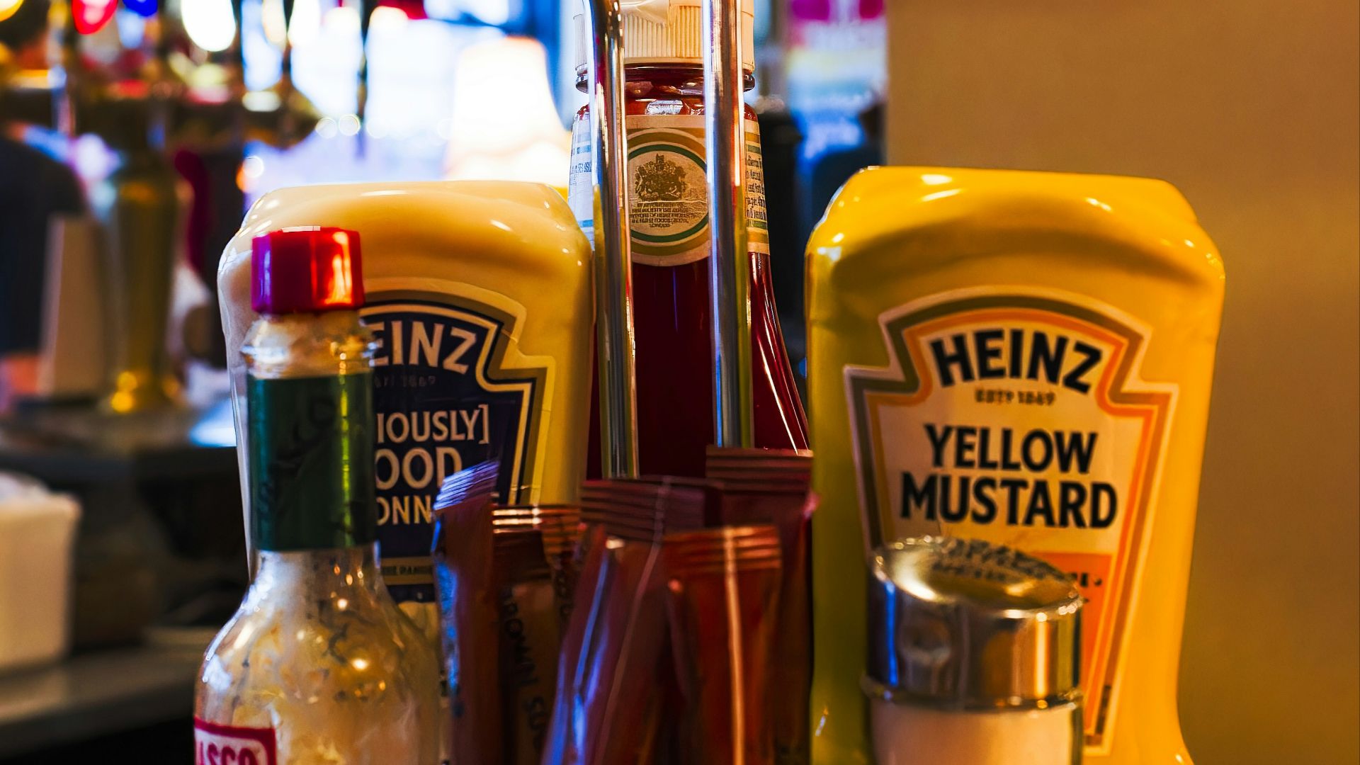 a basket of condiments sits on a counter in a restaurant