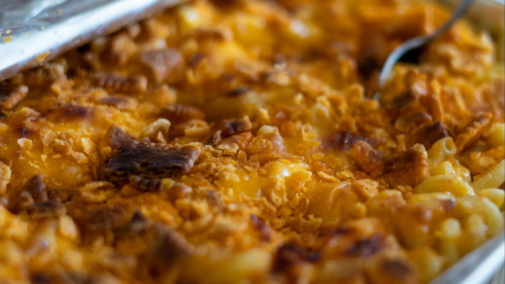 a dish of macaroni and cheese with a spoon in it