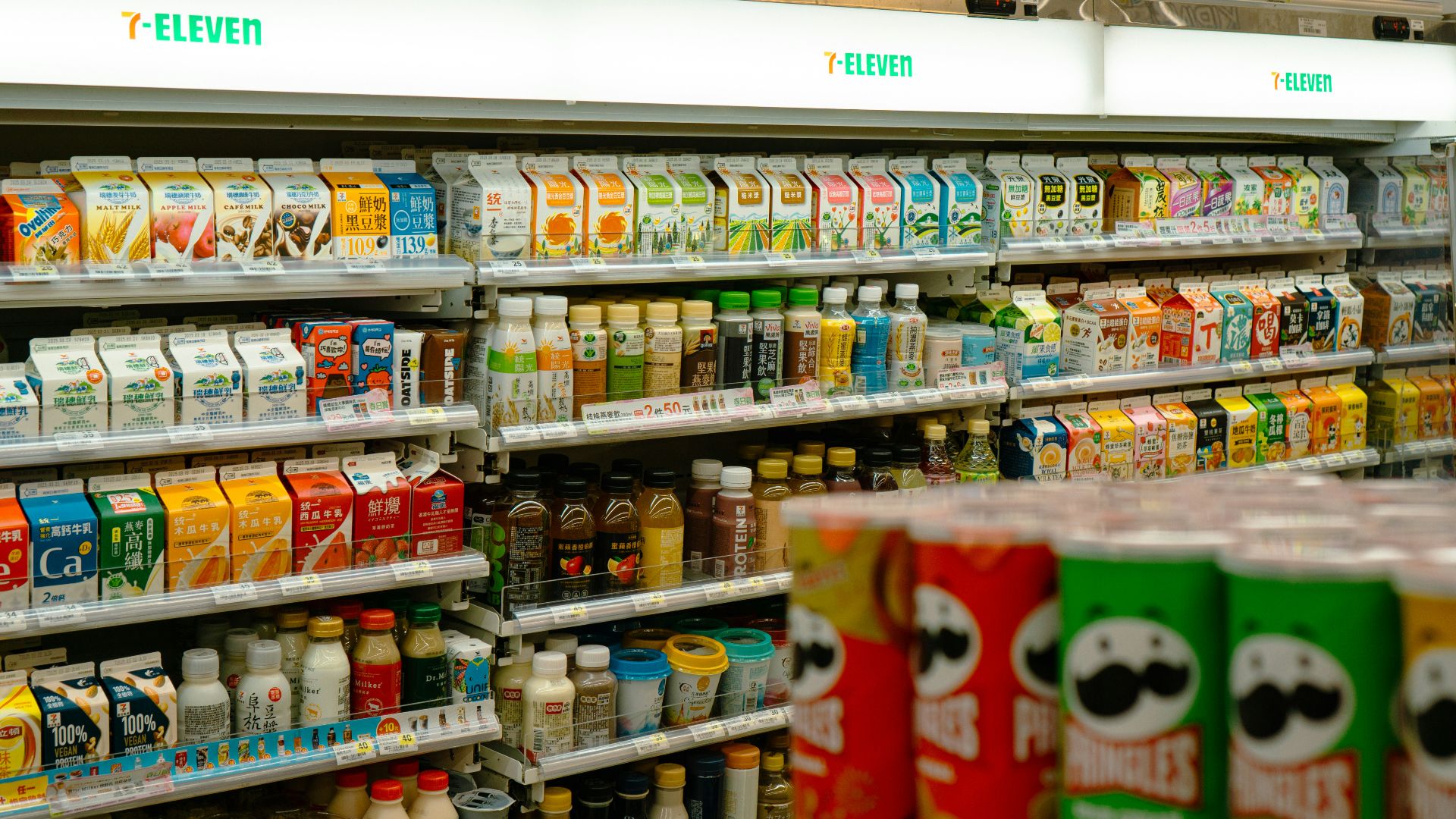 Shelves of snacks and drinks inside a 7-eleven.