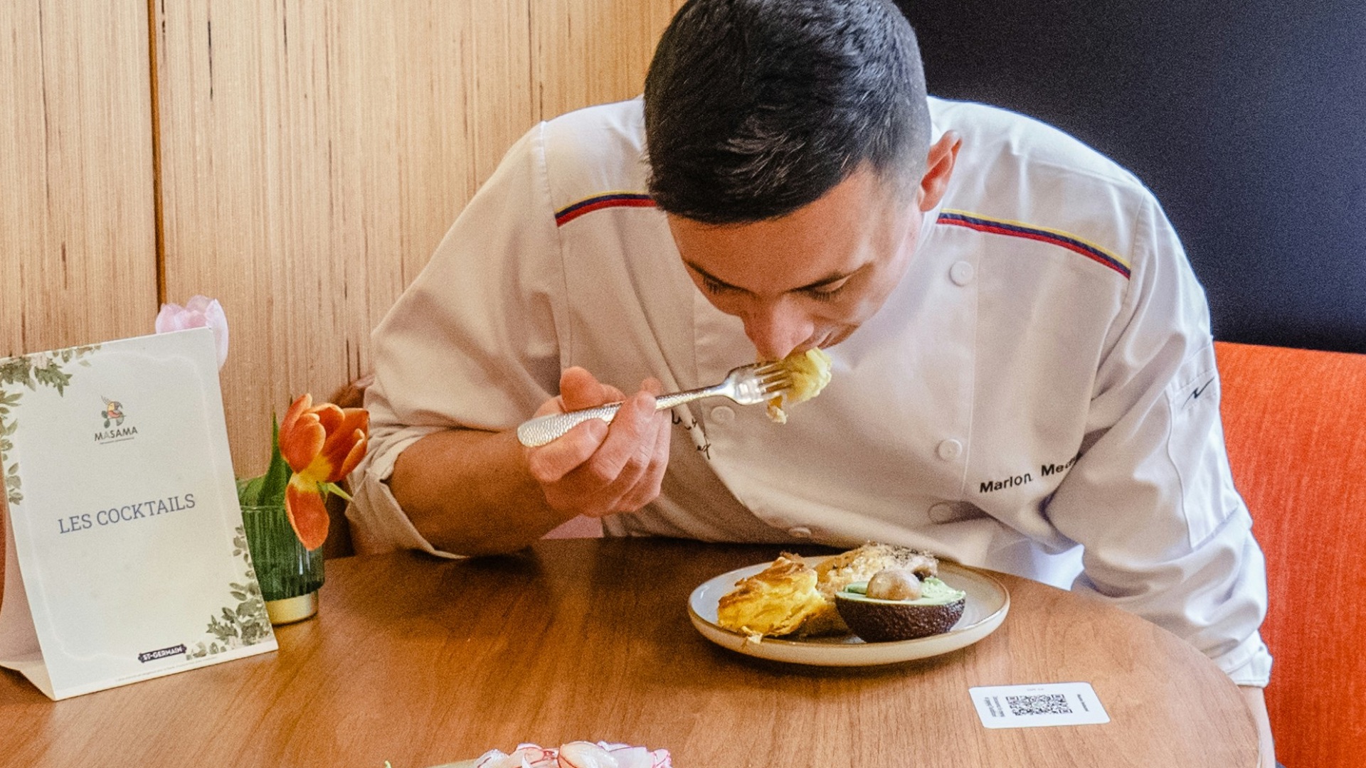 a man sitting at a table eating food