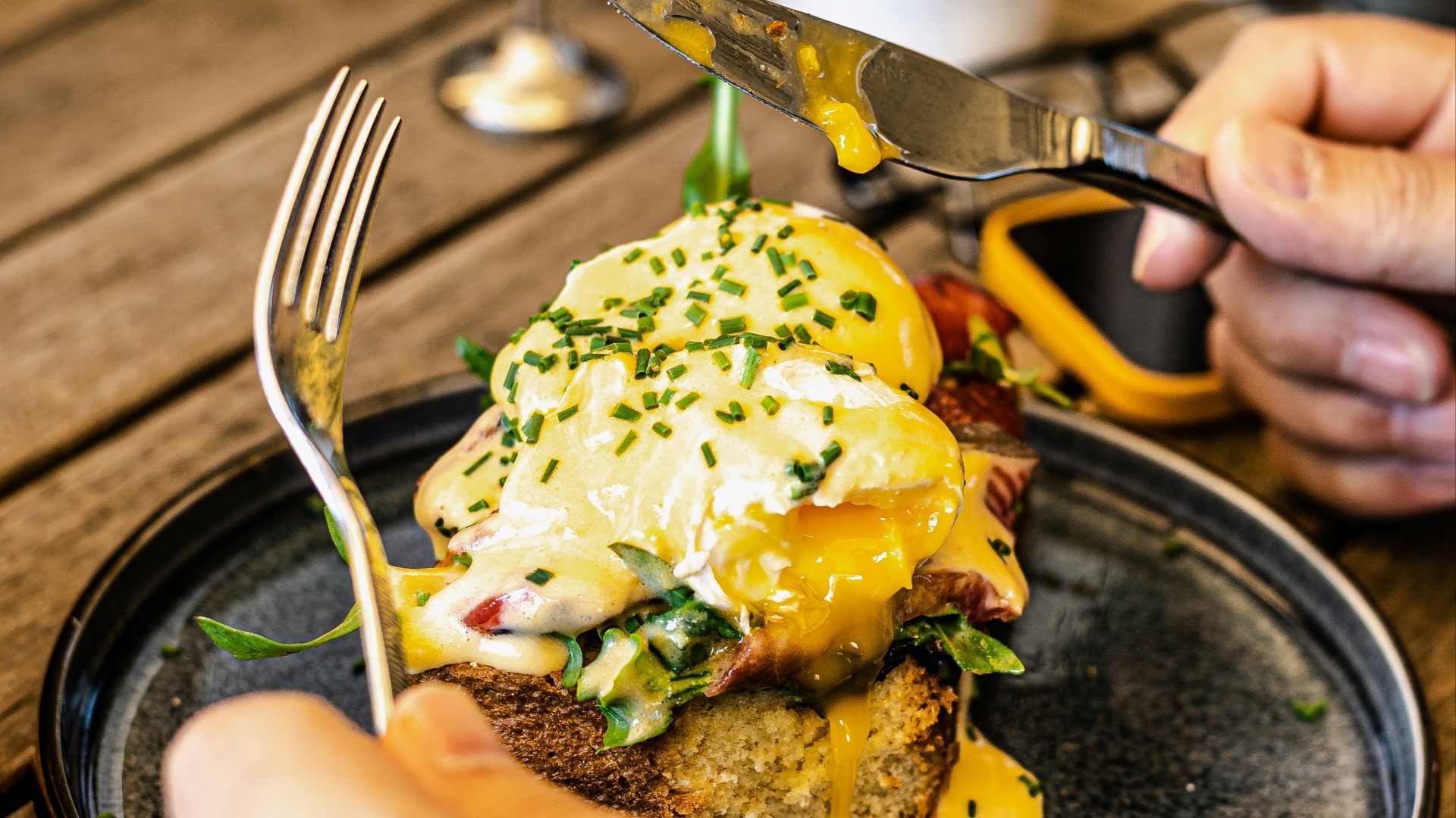person holding stainless steel fork and knife