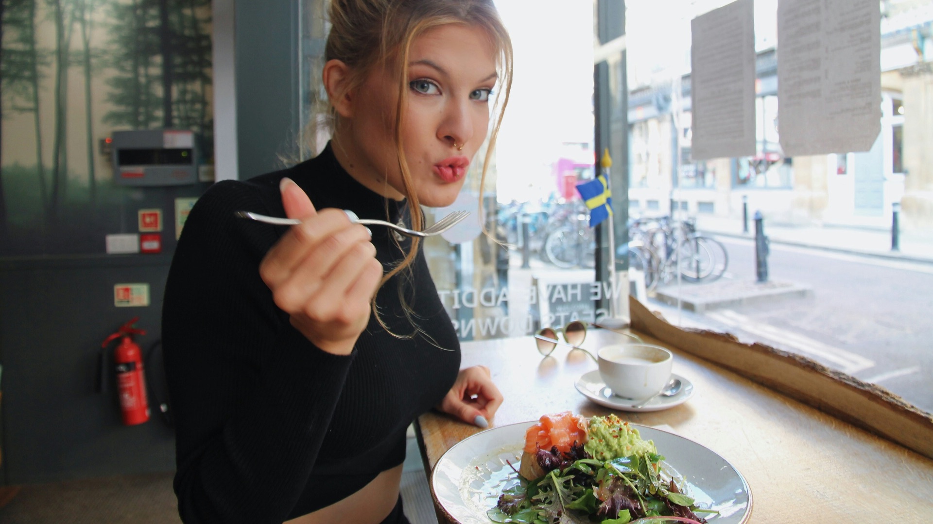 woman in black long sleeve shirt eating