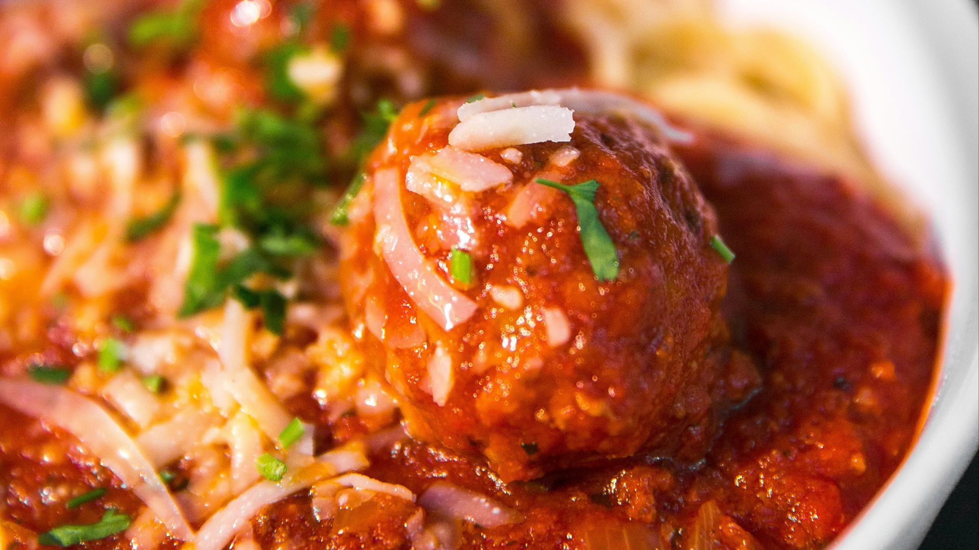 meta balls with noodles served on white ceramic bowl
