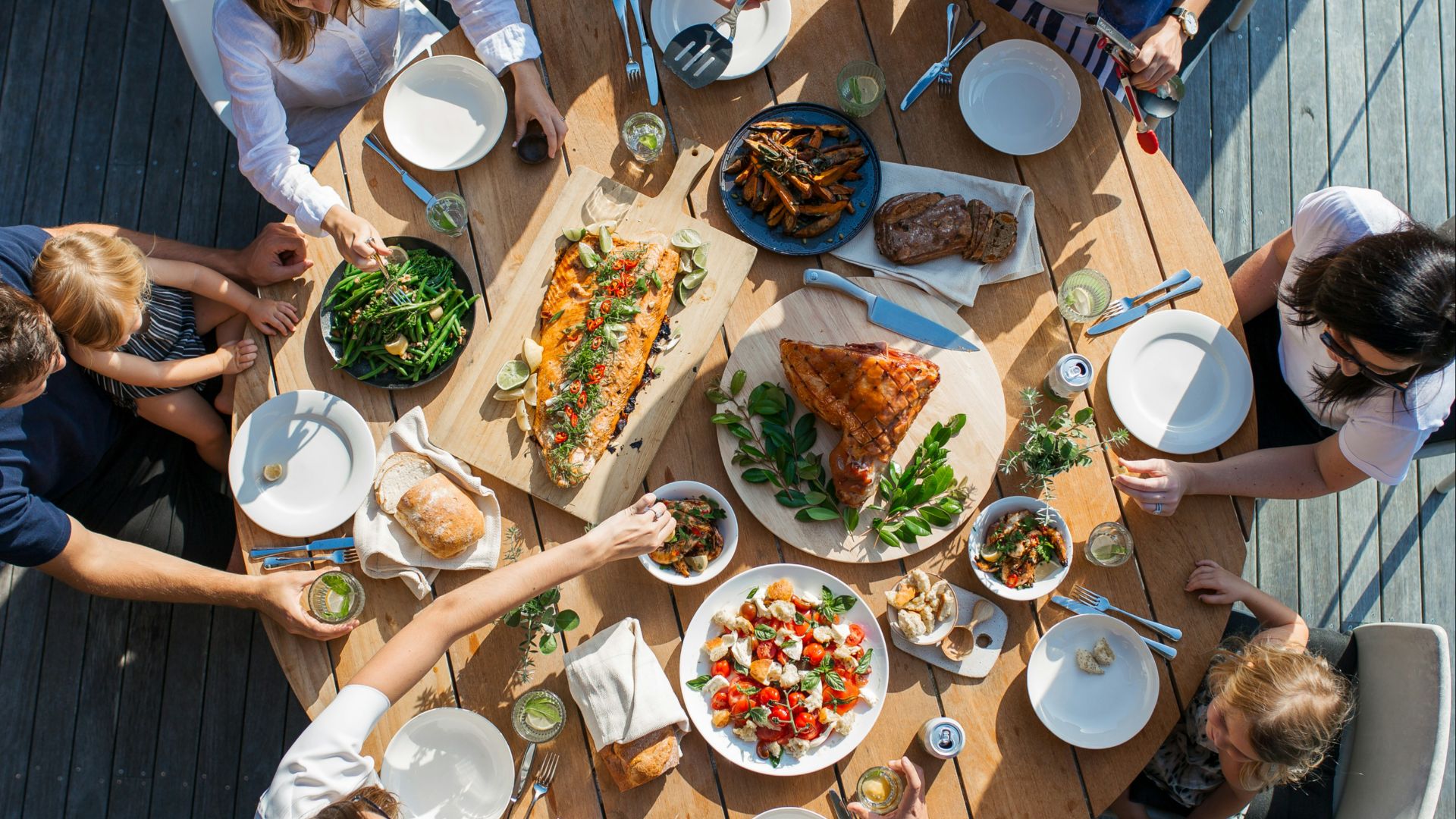 people eating on table with foods