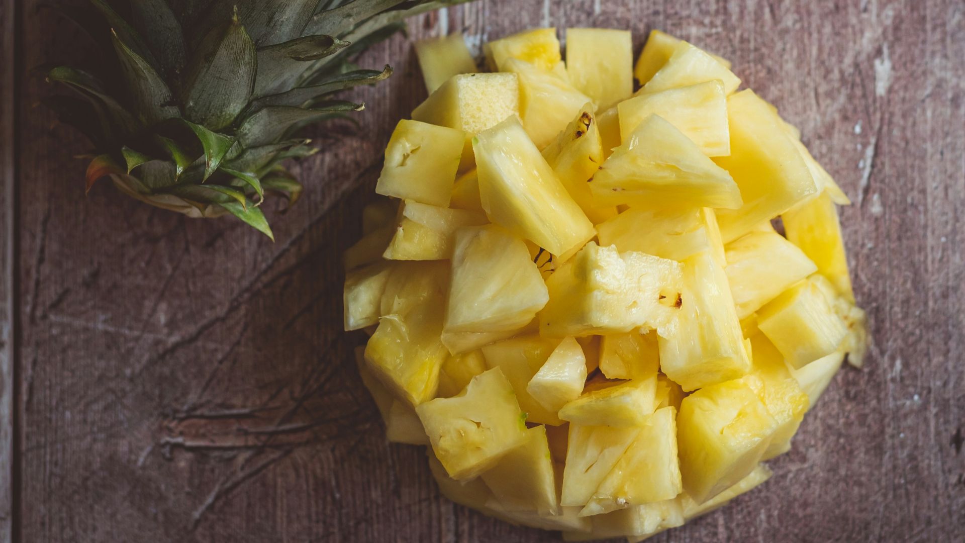 yellow rose on brown wooden table