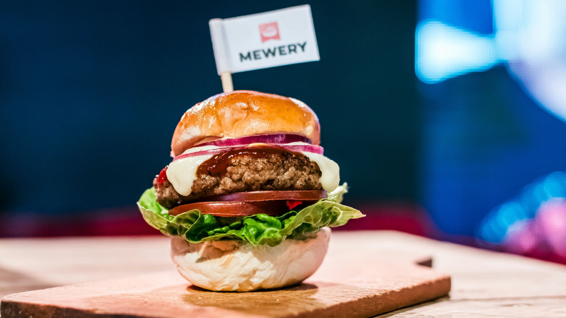 a hamburger sitting on top of a wooden cutting board