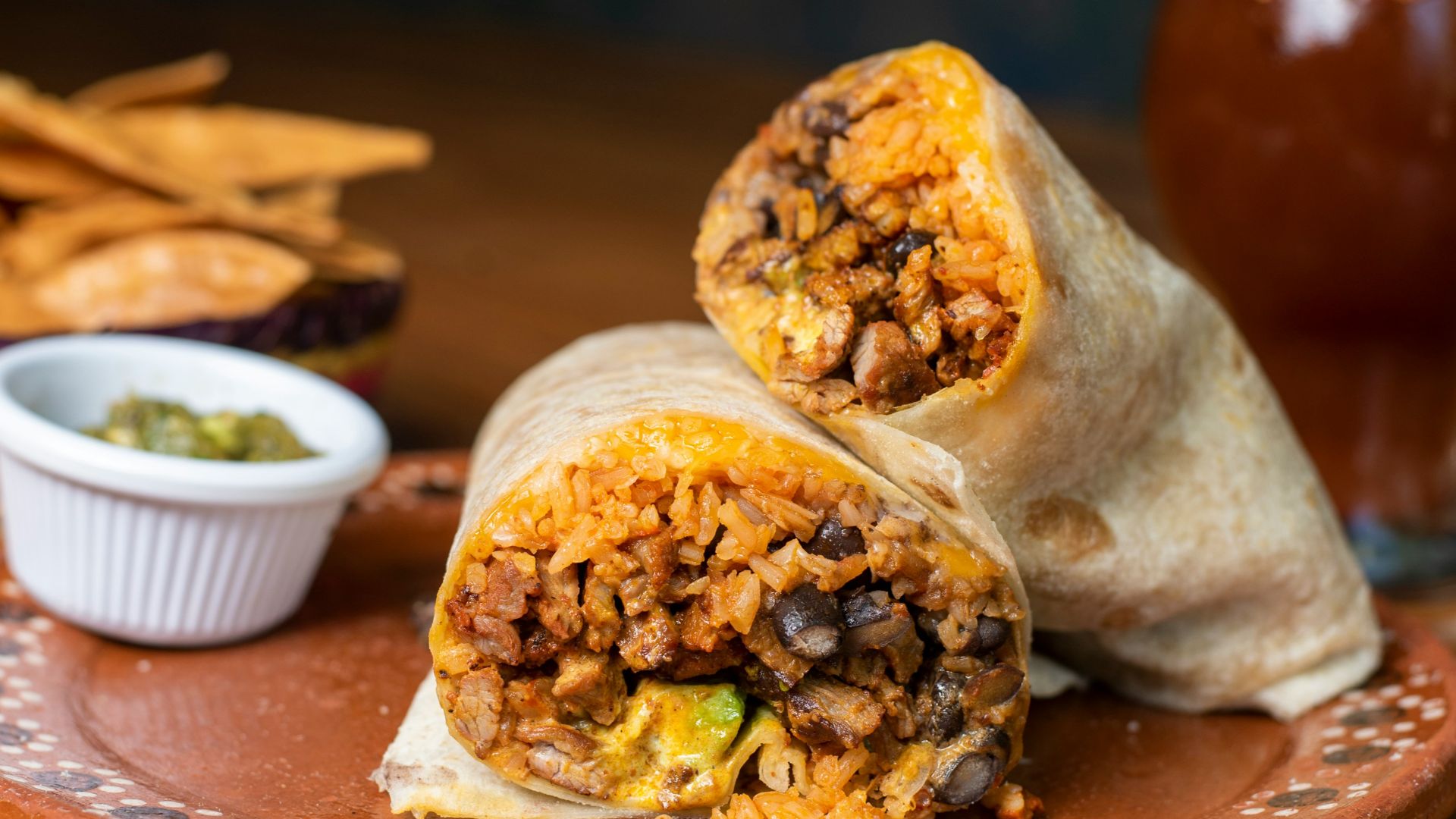 A burrito cut in half on a plate