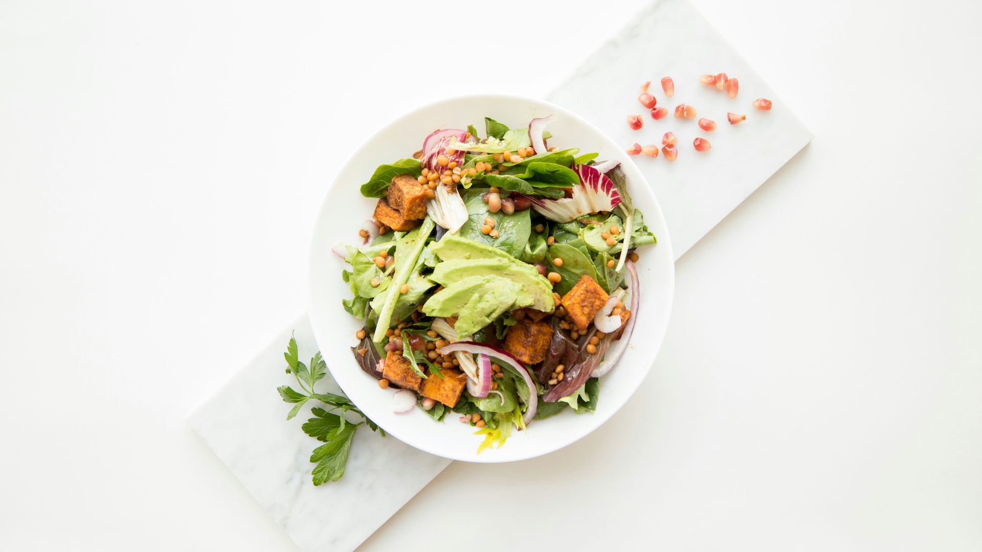cooked food with sliced vegetables in white bowl