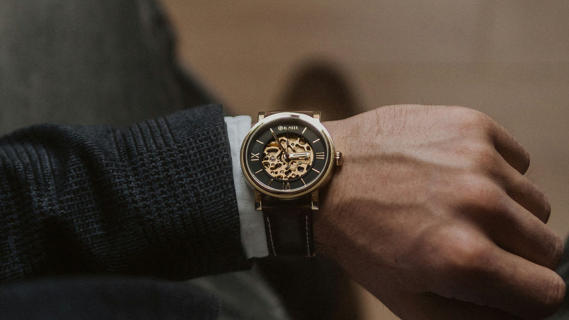 person wearing gold and silver round analog watch