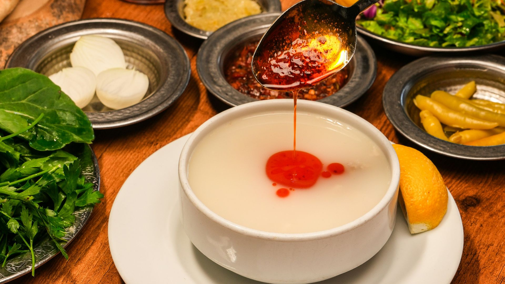 A wooden table topped with plates and bowls filled with food