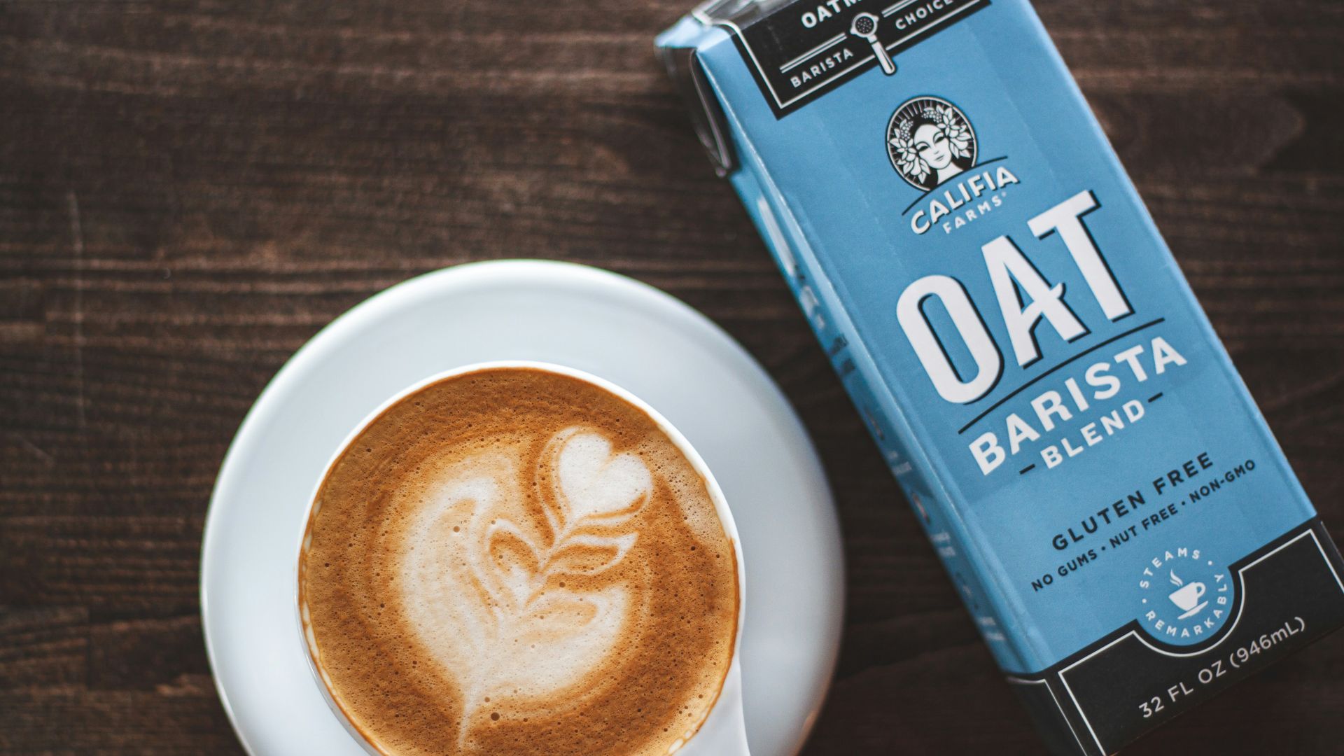 cup of latte beside oat barista box