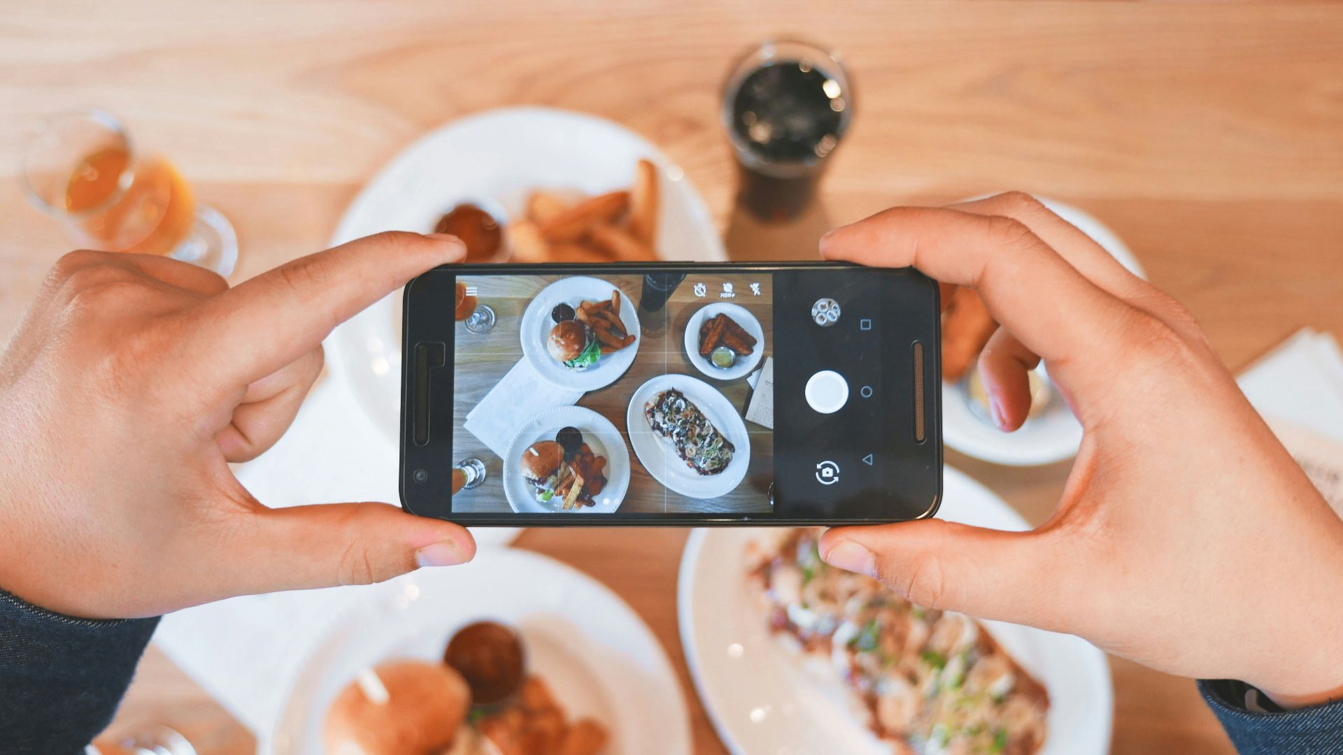 person taking picture of the foods
