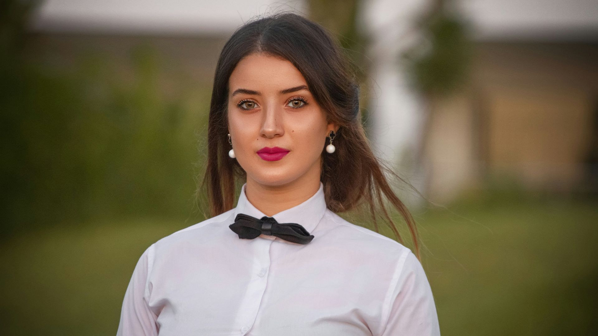 woman in white dress shirt and black bowtie