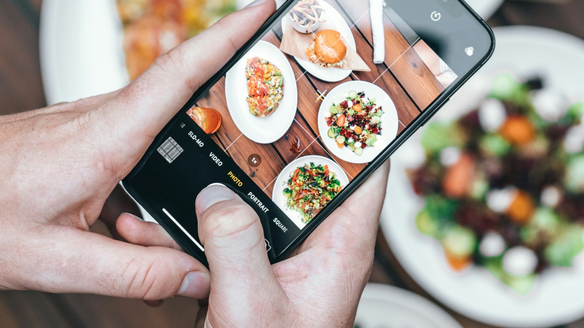 person taking photo of food