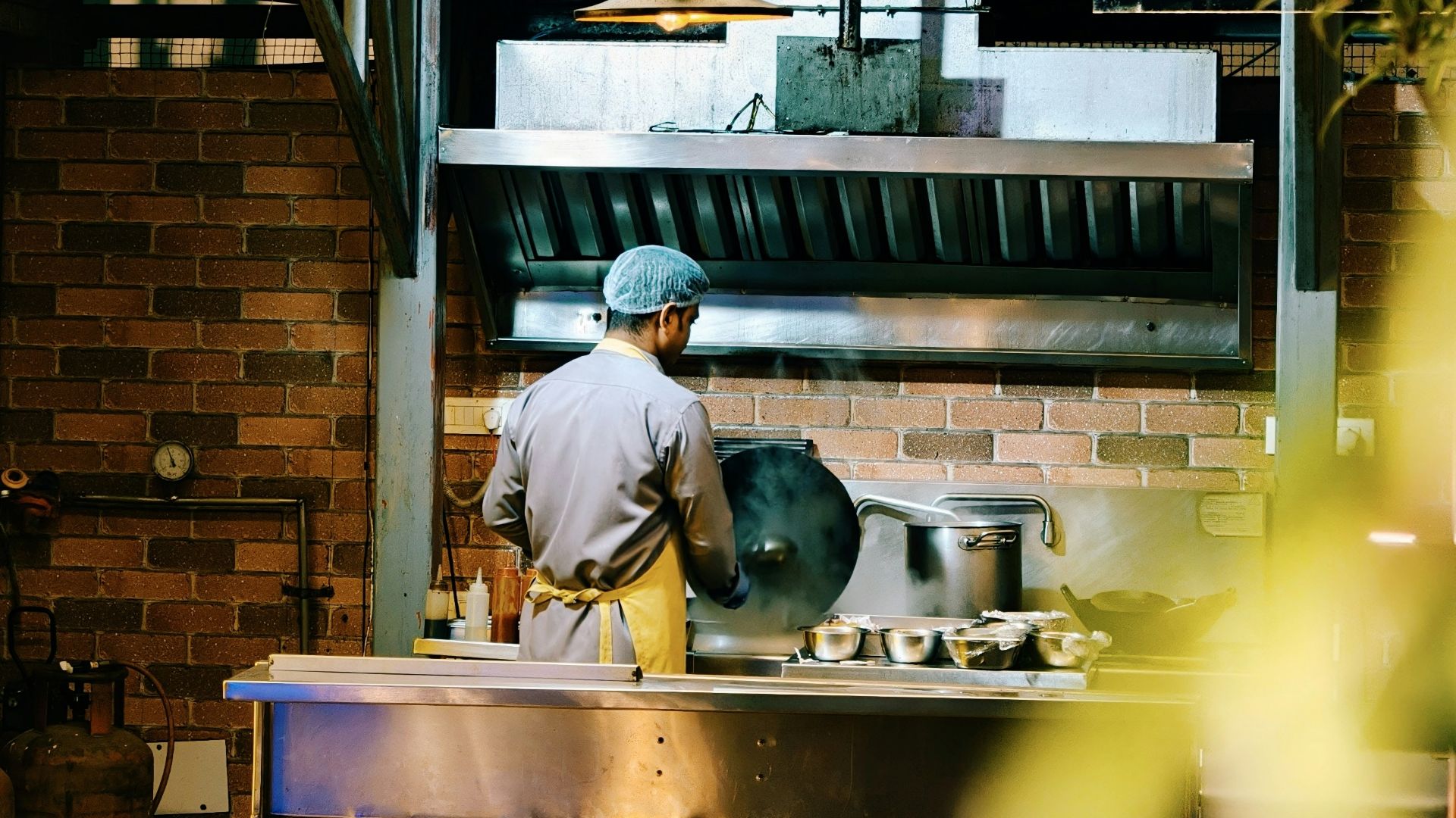 Chef working in a commercial kitchen at night.