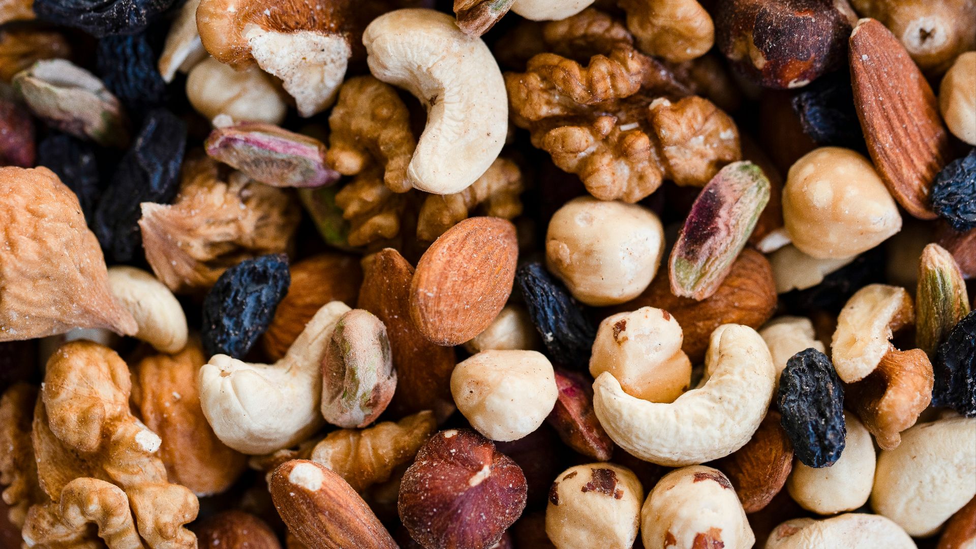 A close-up view of a mixed nut and raisin blend.