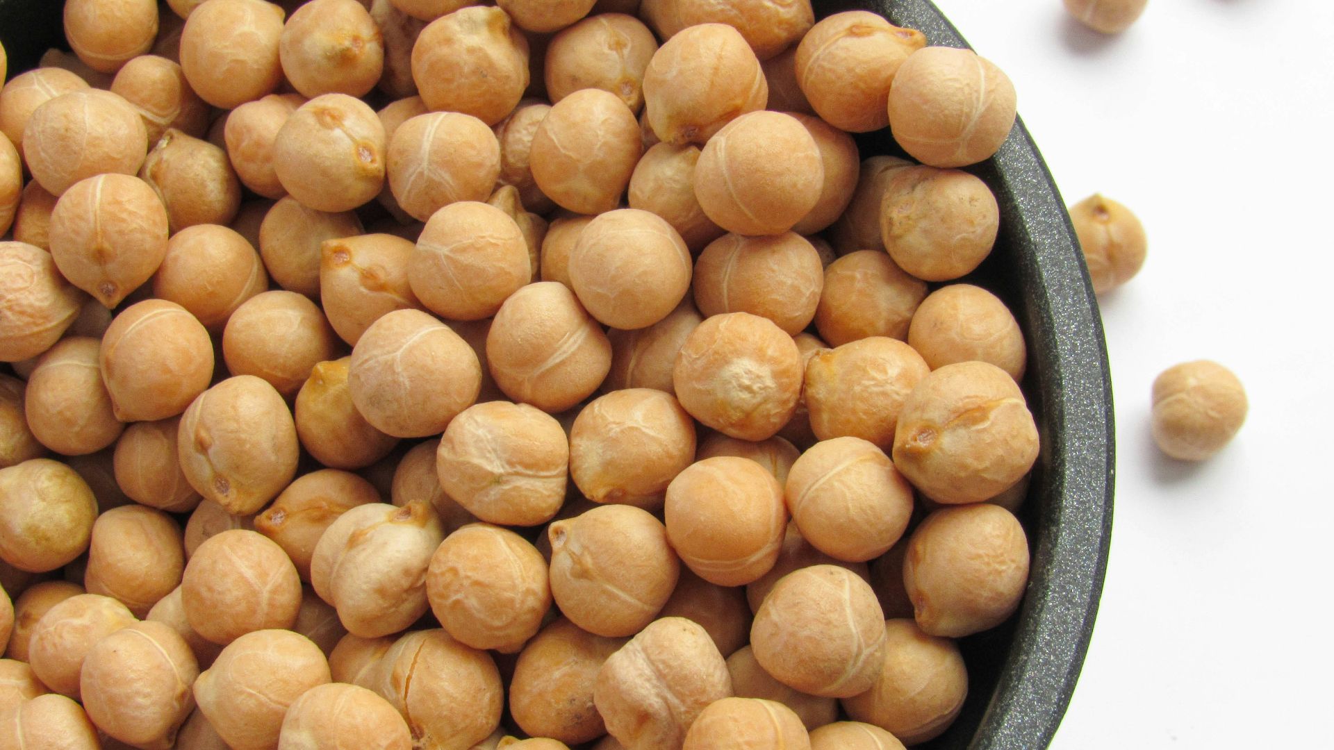 a bowl filled with chickpeas sitting on top of a table