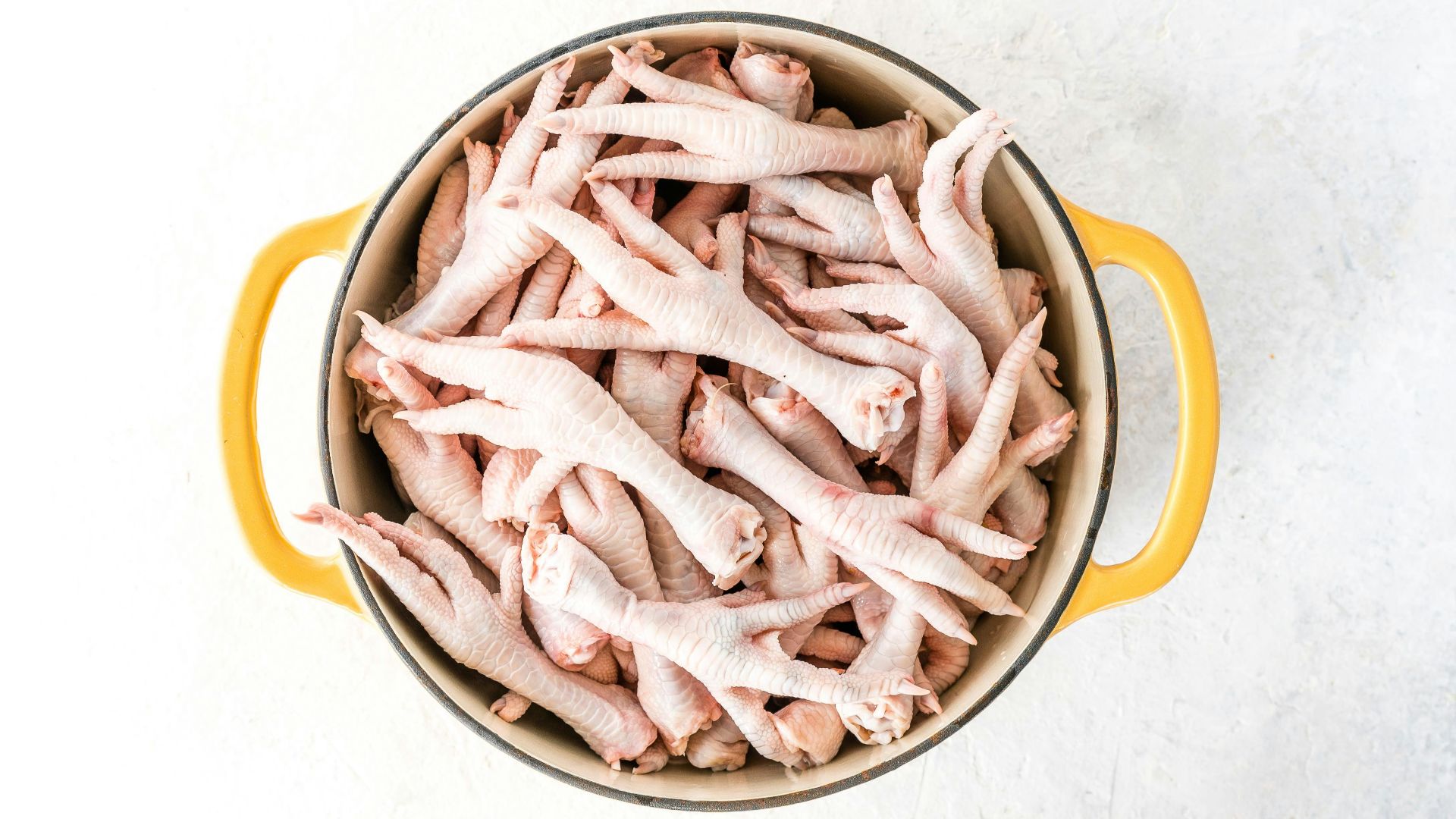a pot filled with raw chicken on top of a table