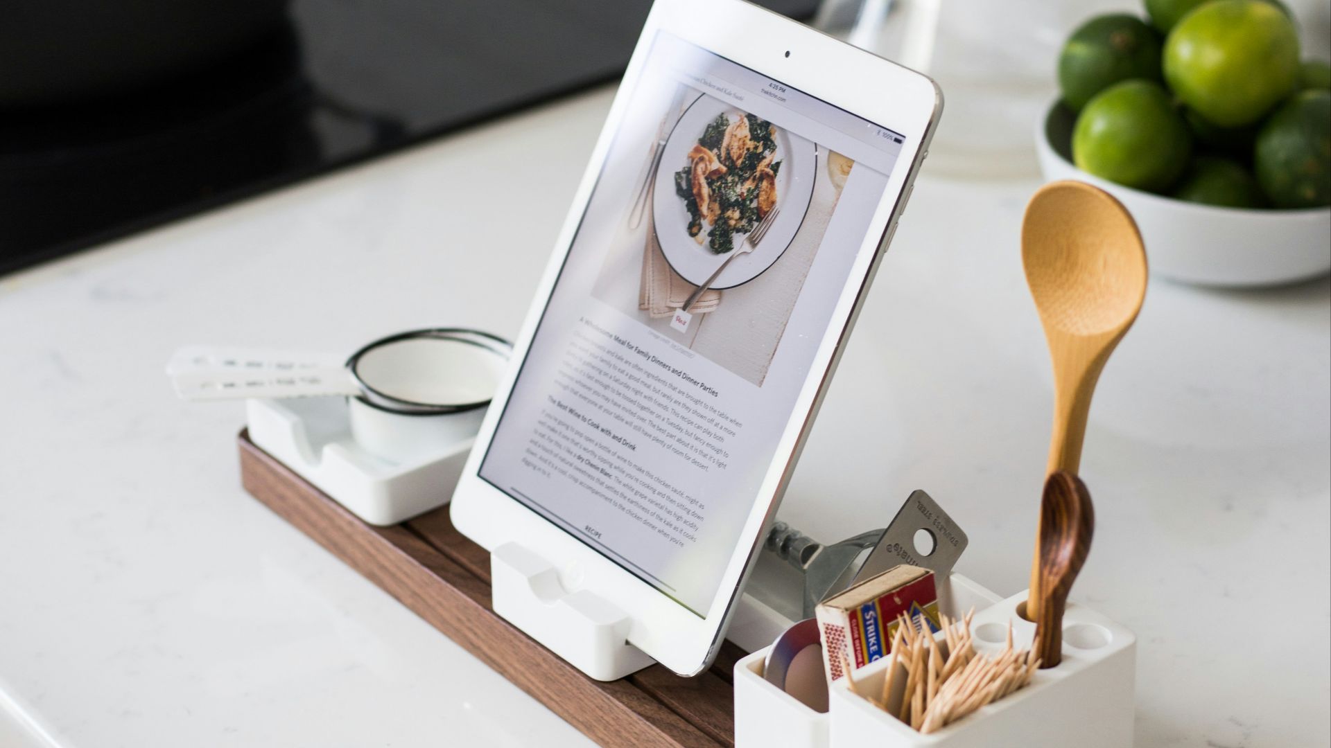 closeup photo of turned on iPad with rack on table