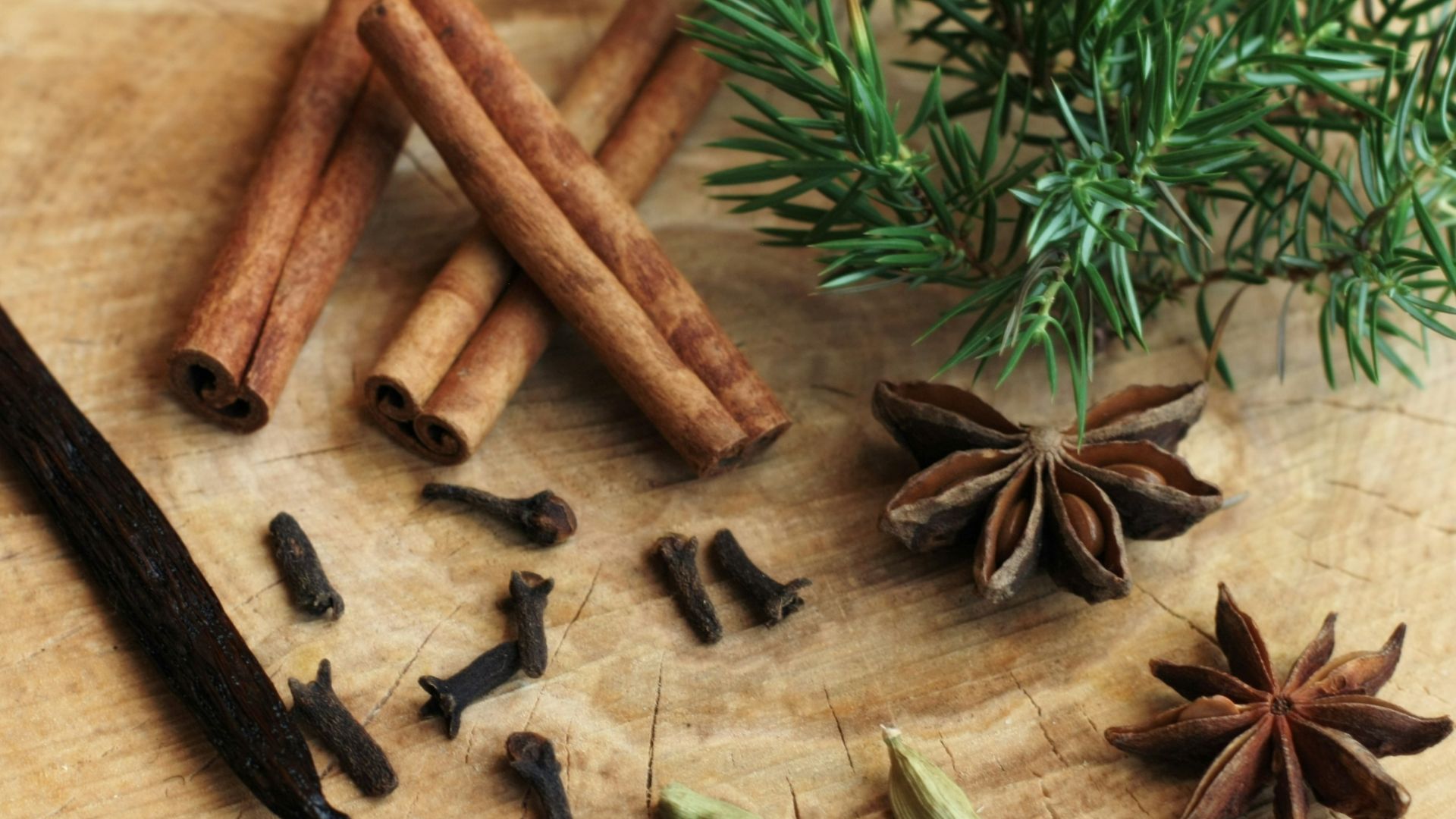 an assortment of spices sitting on top of a wooden cutting board