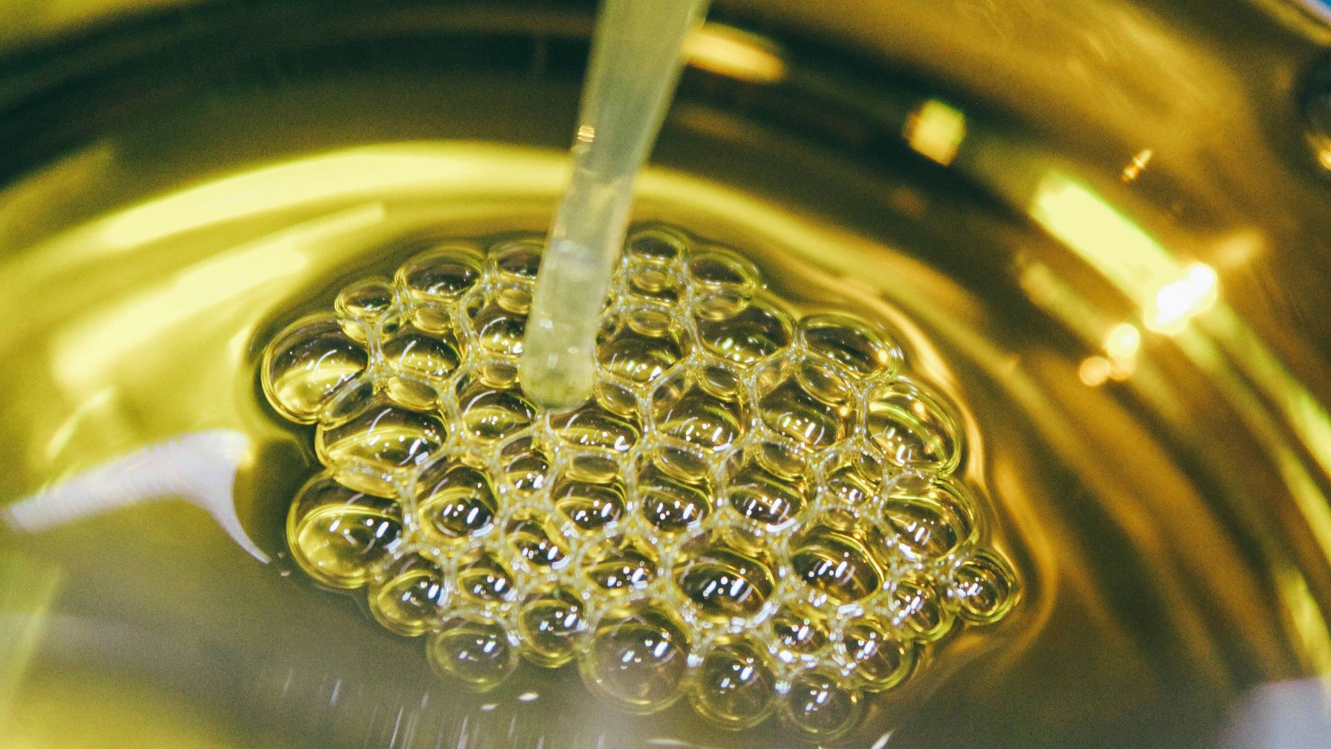 a metal bowl filled with yellow liquid