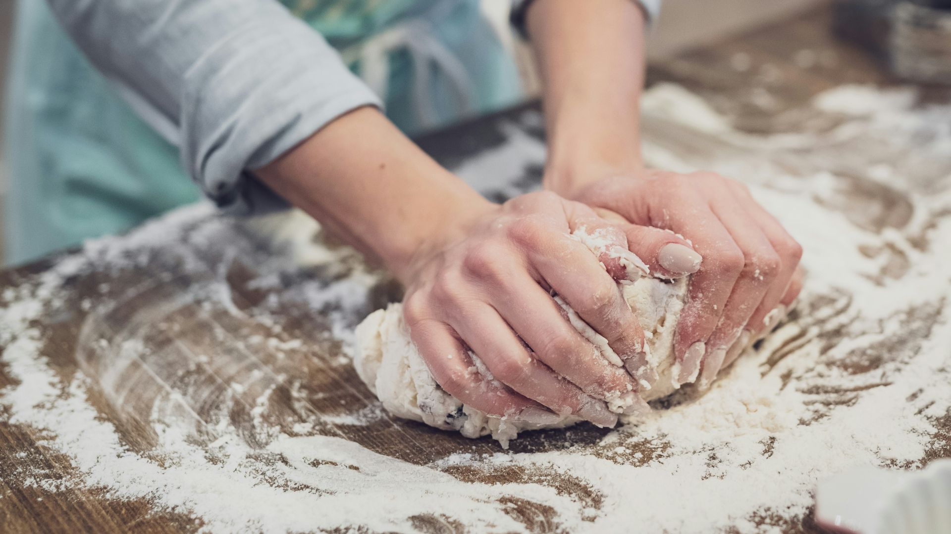 person standing and making dough