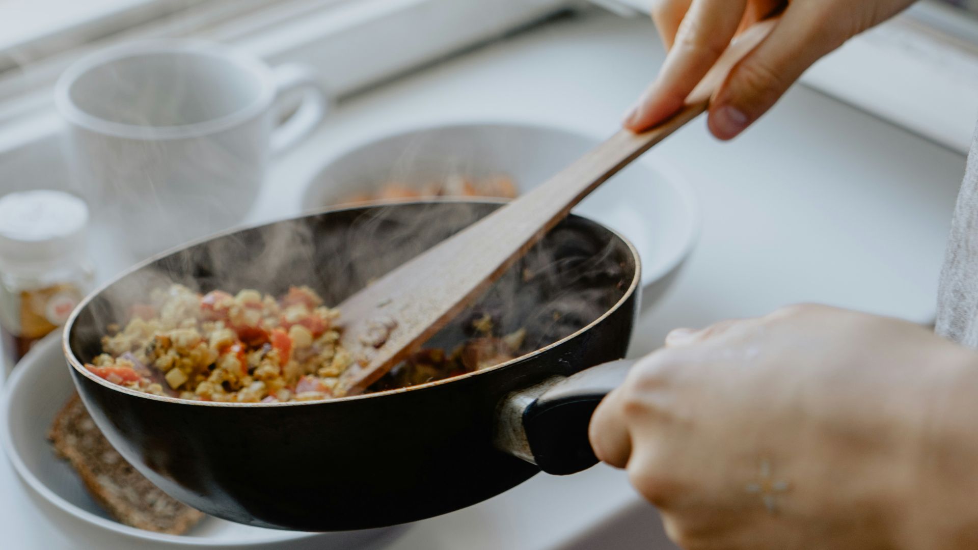 person holding black frying pan