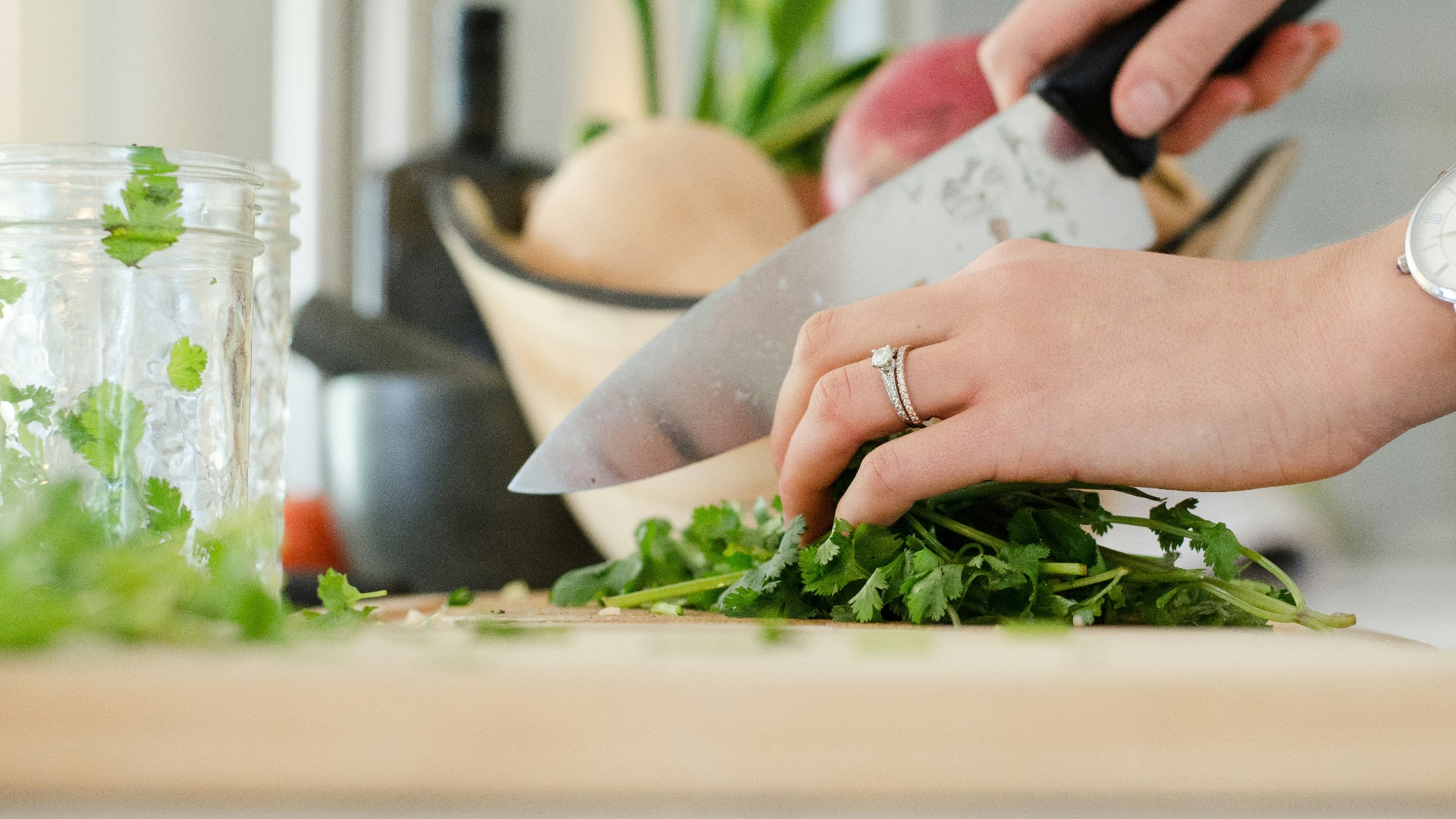 person cutting vegetables with knife