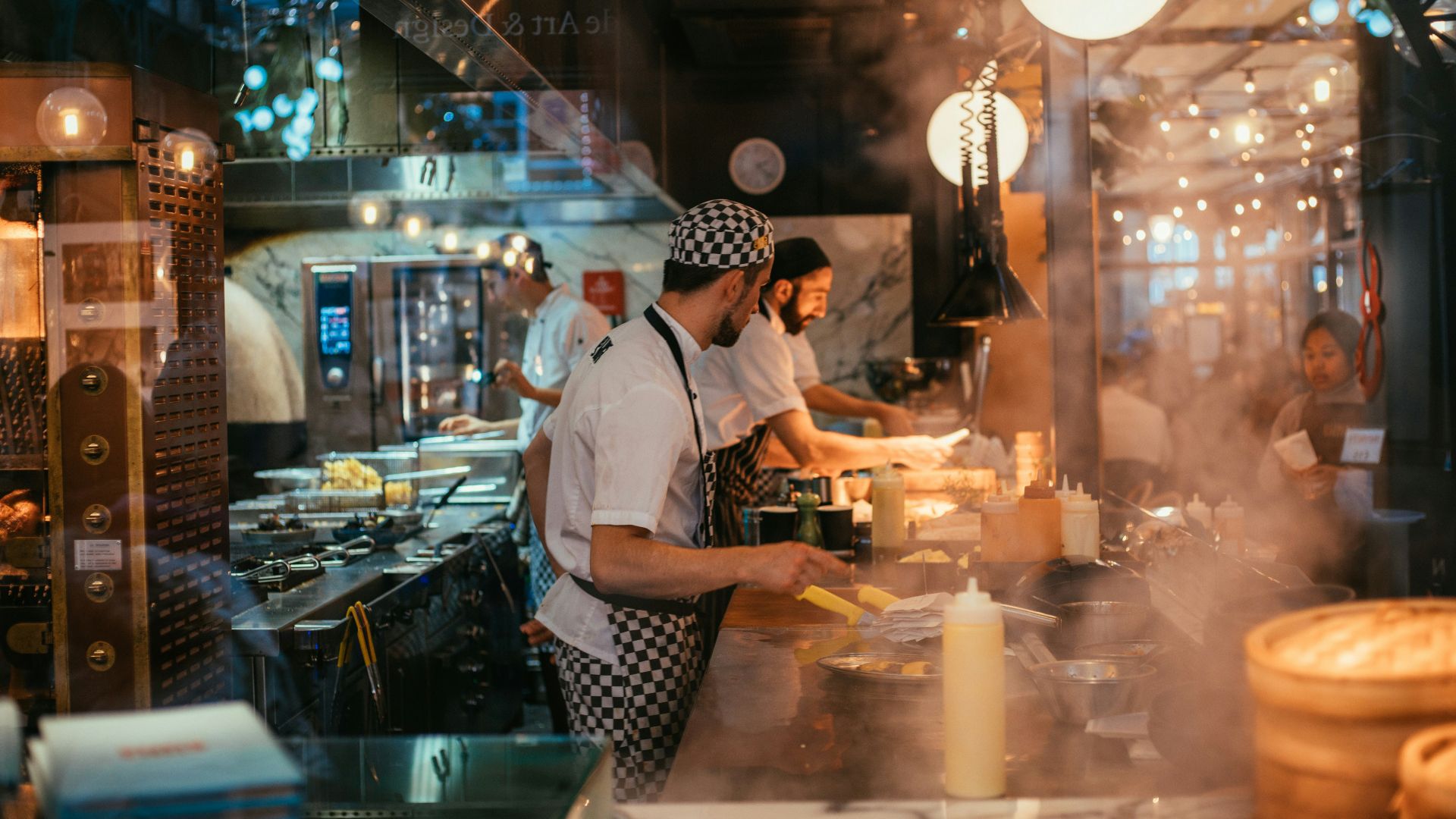shallow focus photo of man wearing black and white apron