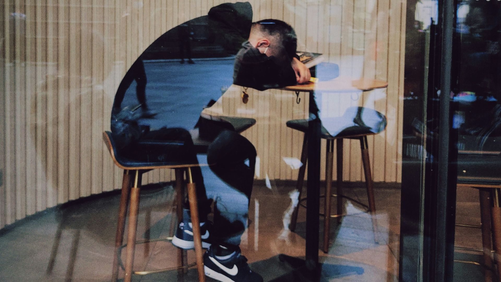 man in black jacket sitting on chair