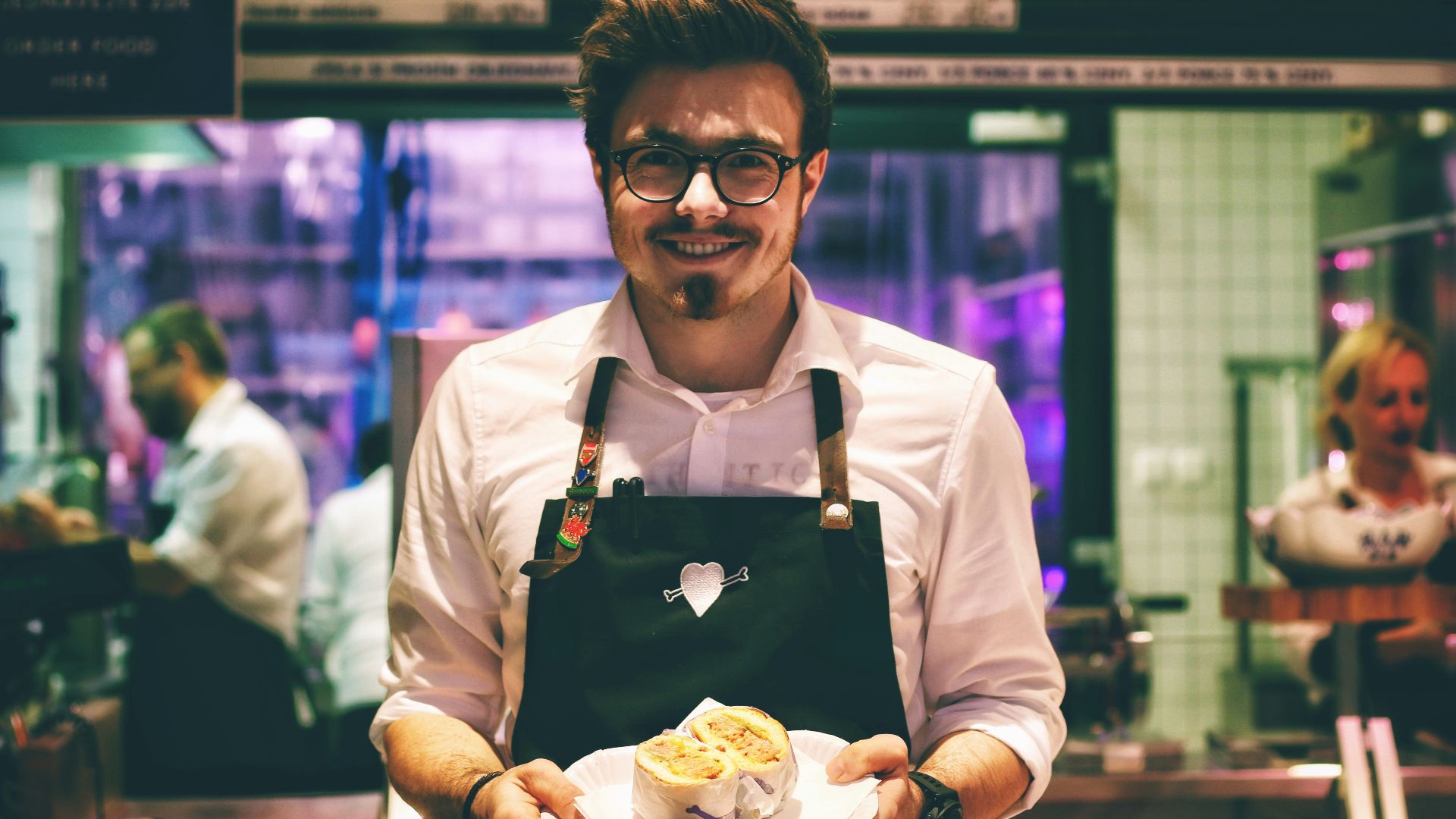 man holding fish dish on plate