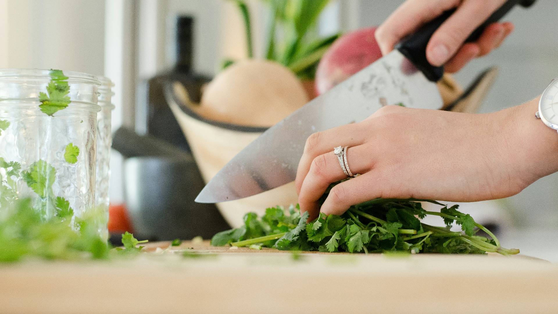 person cutting vegetables with knife