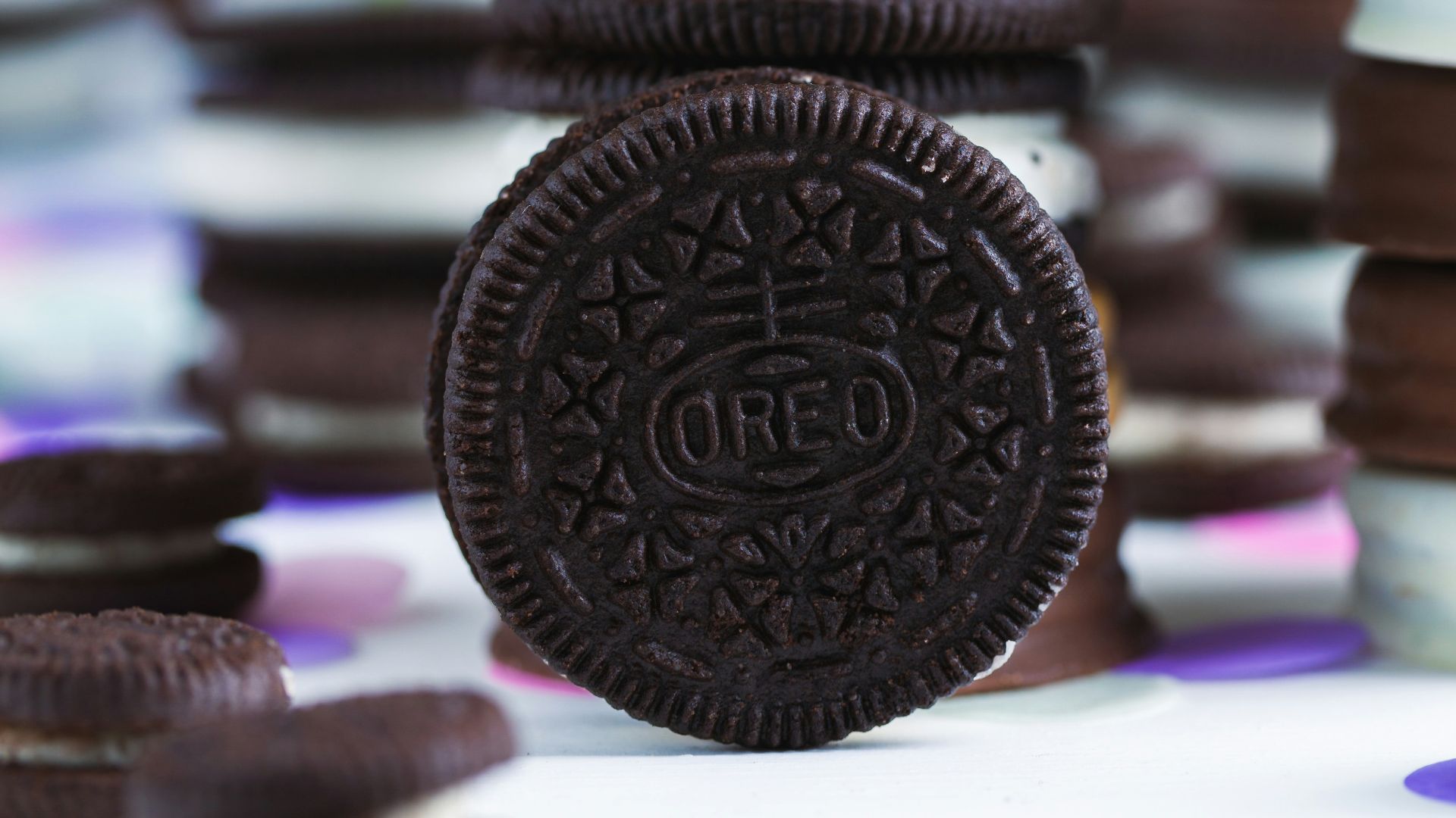 an oreo cookie sitting on top of a pile of cookies