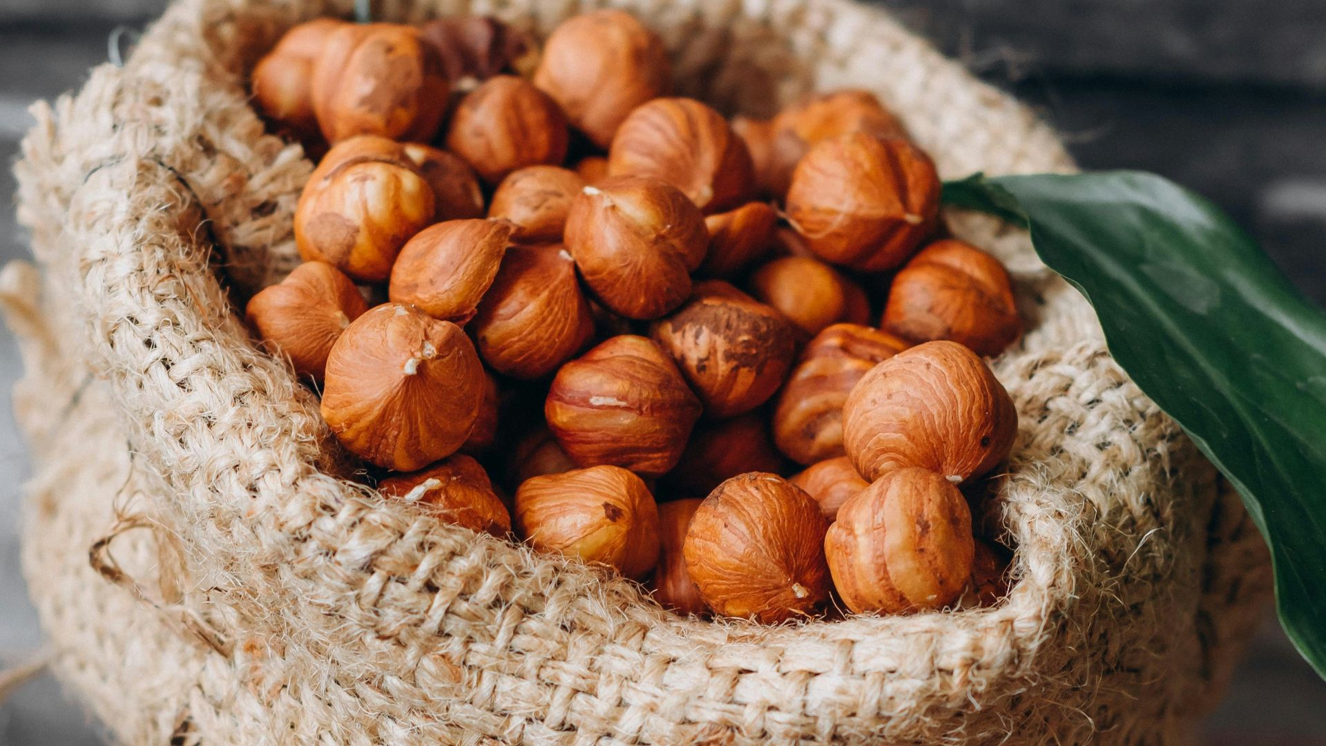 brown round nut on white woven basket