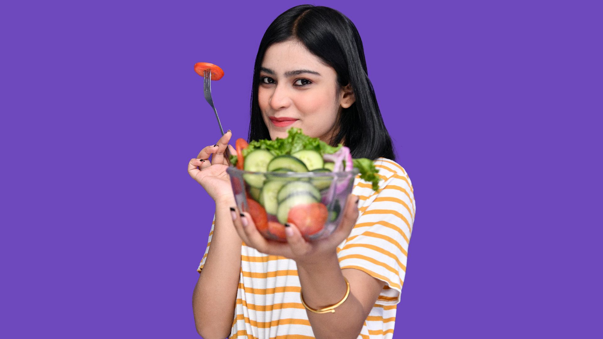 a woman holding a bowl of fruit