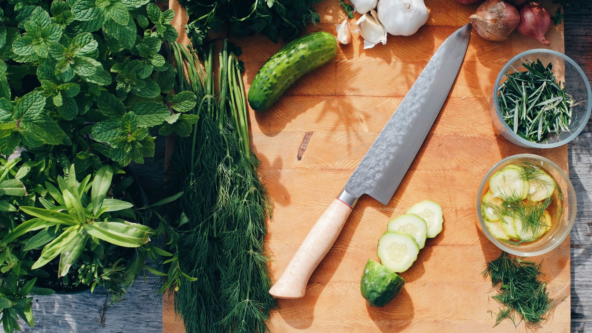 sliced cucumber and green vegetable on brown wooden chopping board