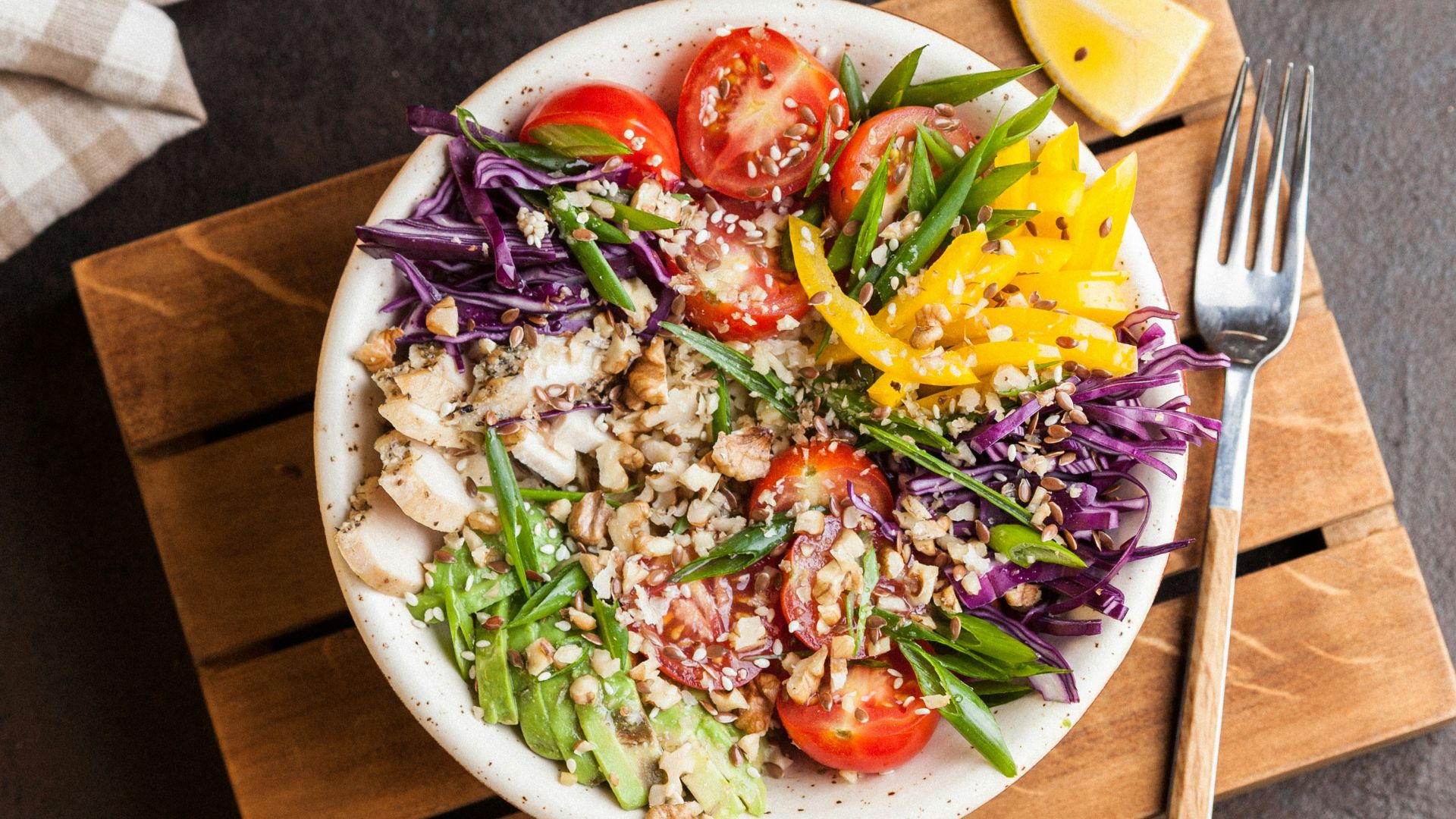 plate full of salad with spice on top of brown board