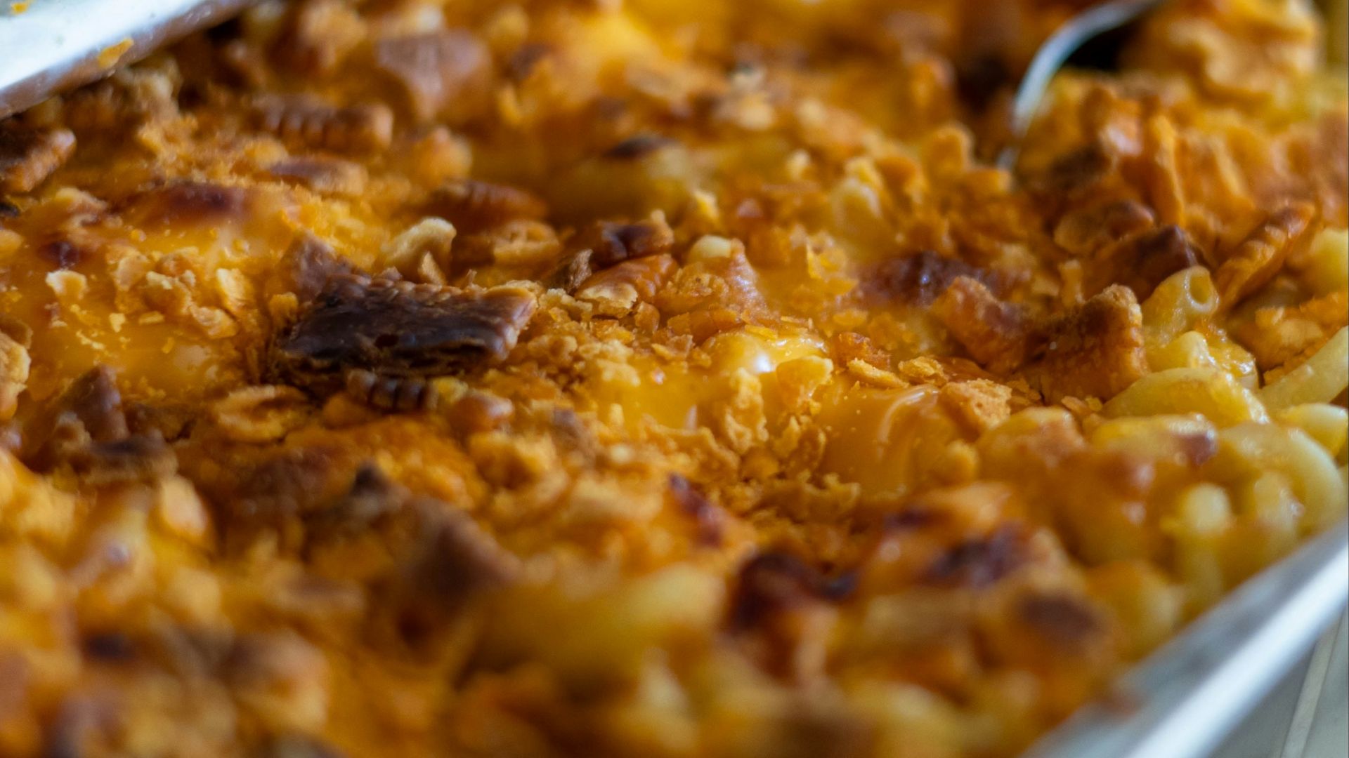 a dish of macaroni and cheese with a spoon in it