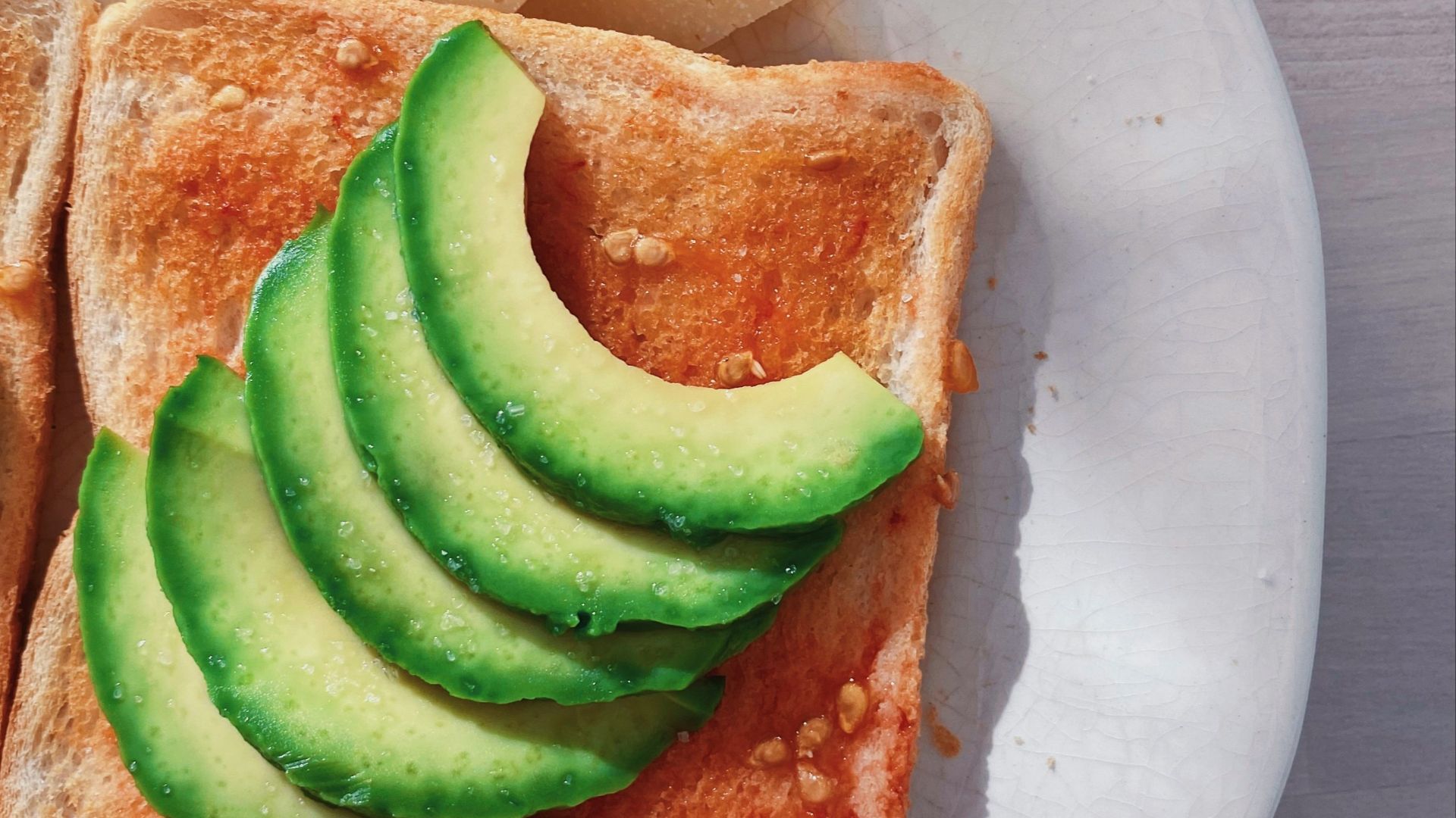 sliced bread with sliced cucumber on white ceramic plate