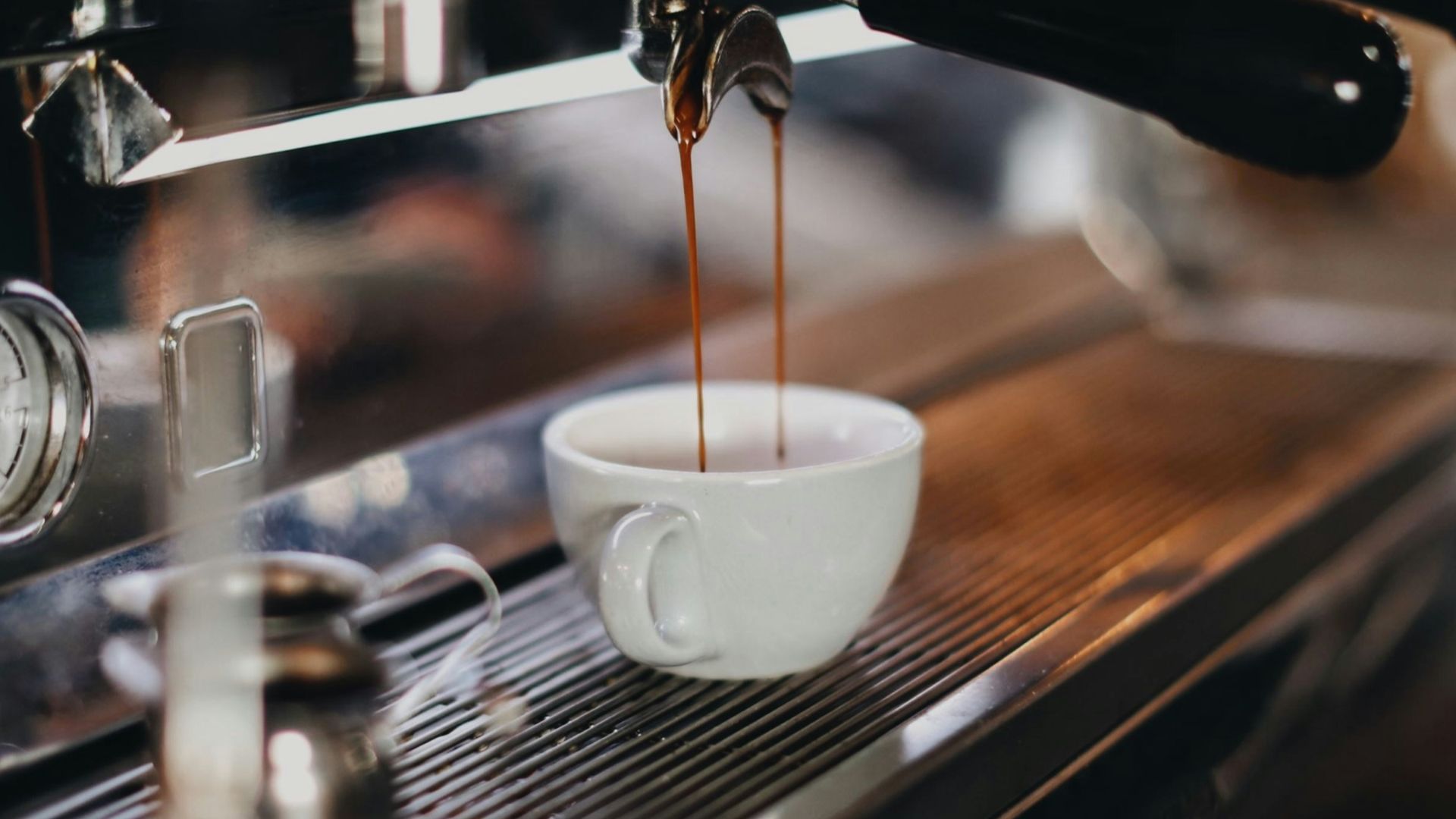 white ceramic cup on brown wooden table