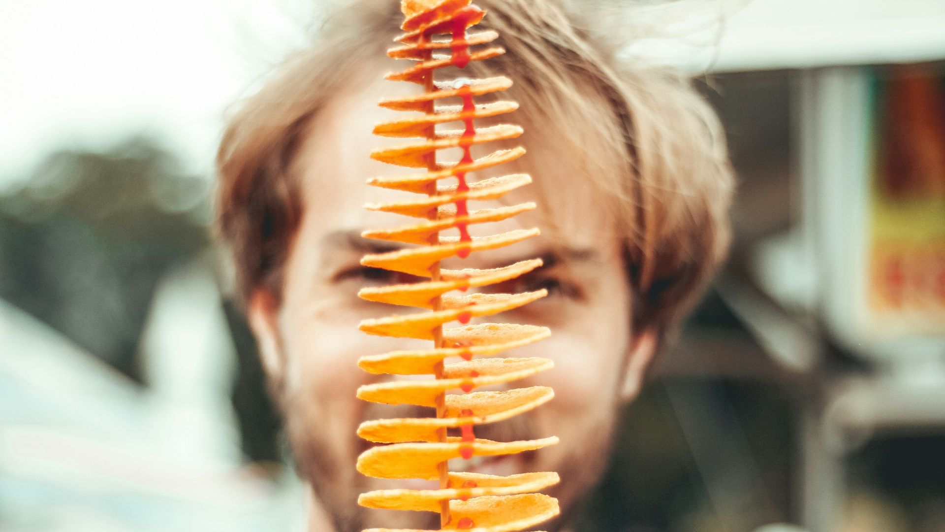 smiling man behind piled chips during daytime