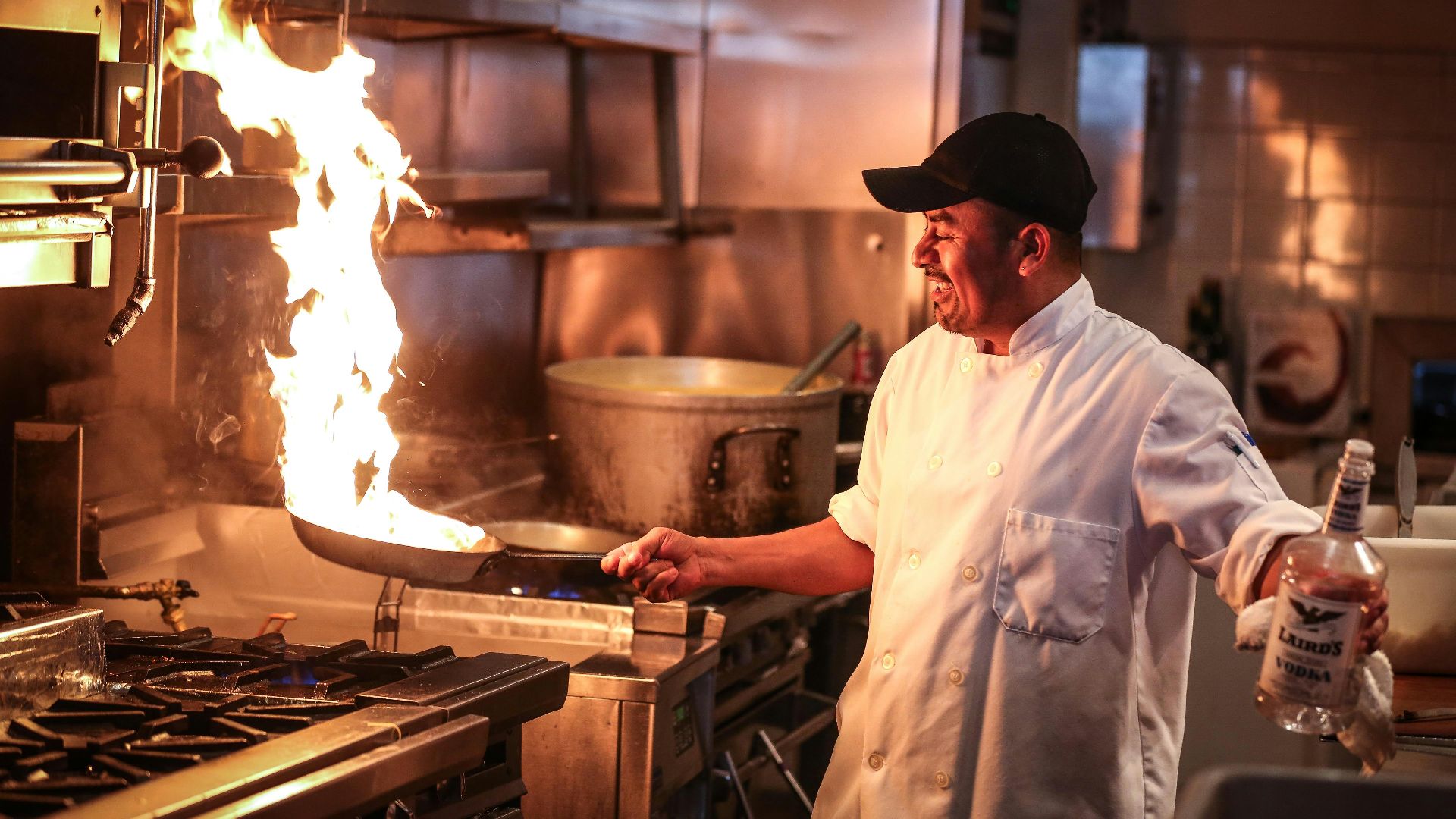 man in white chef uniform cooking
