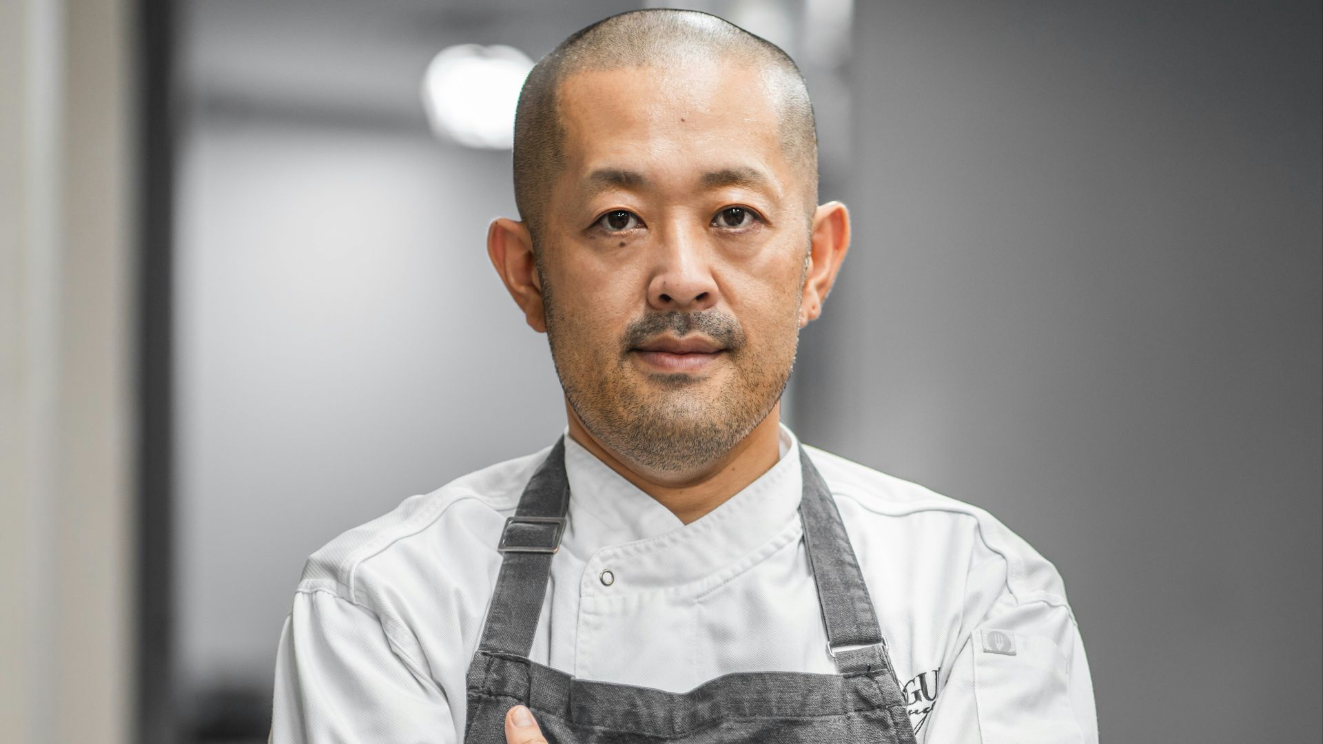 man in white button up shirt and black vest