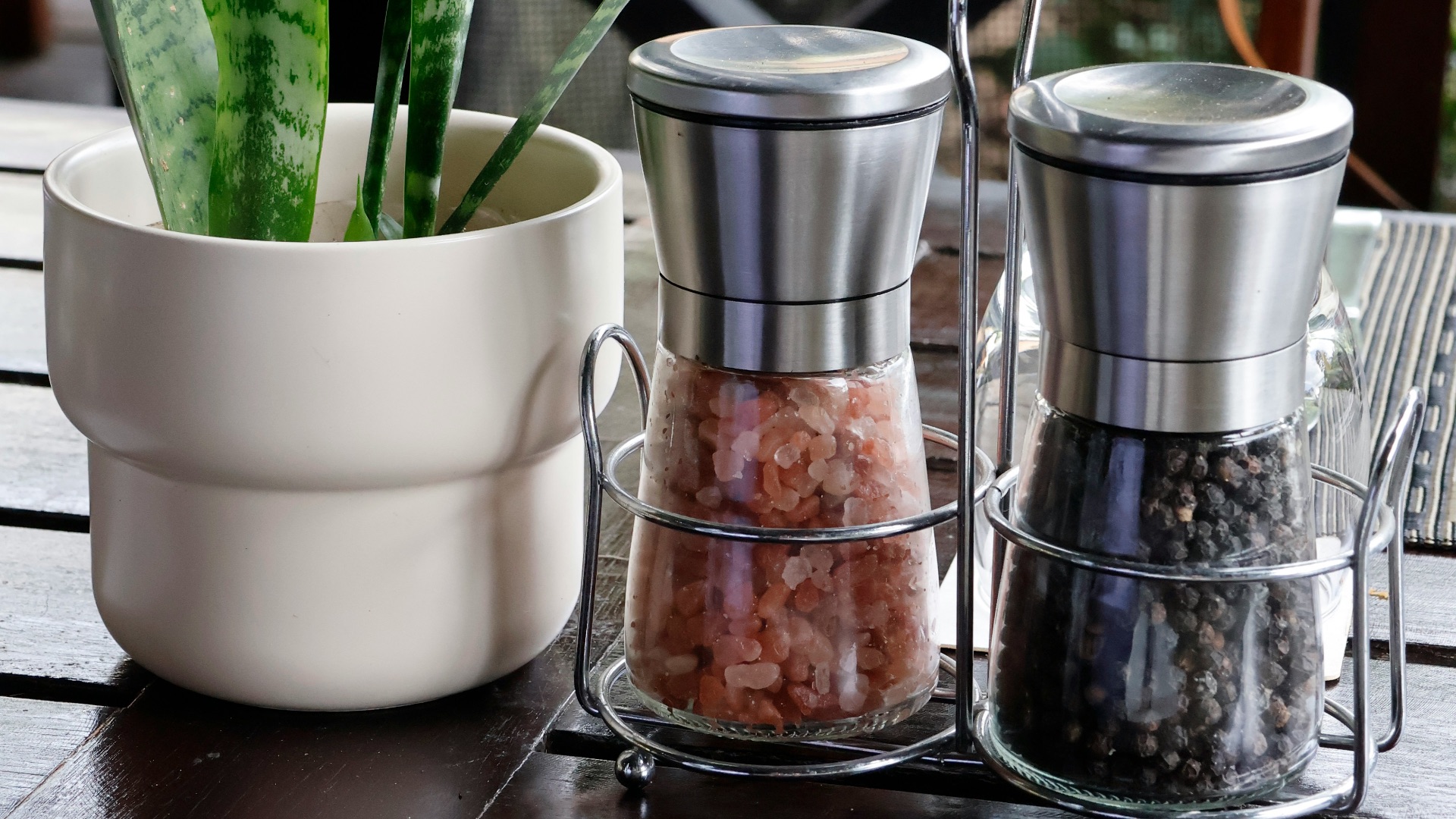 Salt and pepper shakers with plant on table