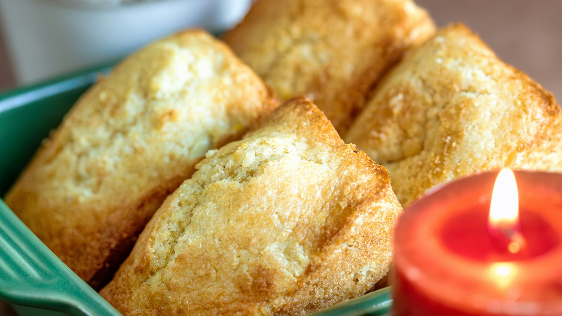 A table topped with plates of food and a candle